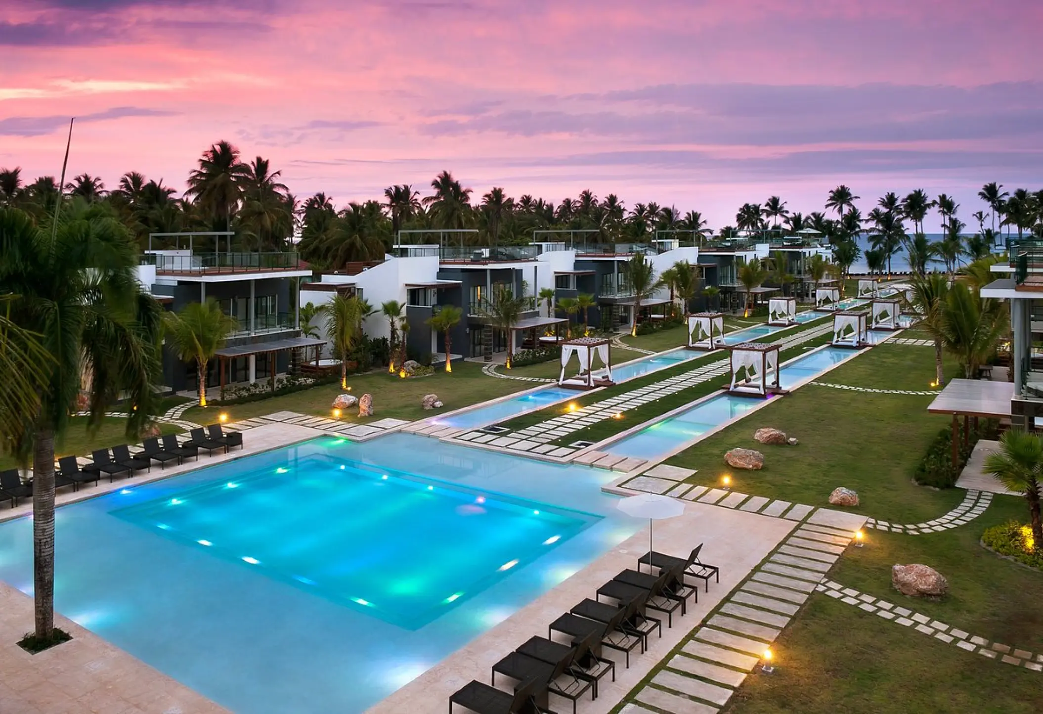 Main swimming pool and villas at Sublime Samaná at sunset, Samana