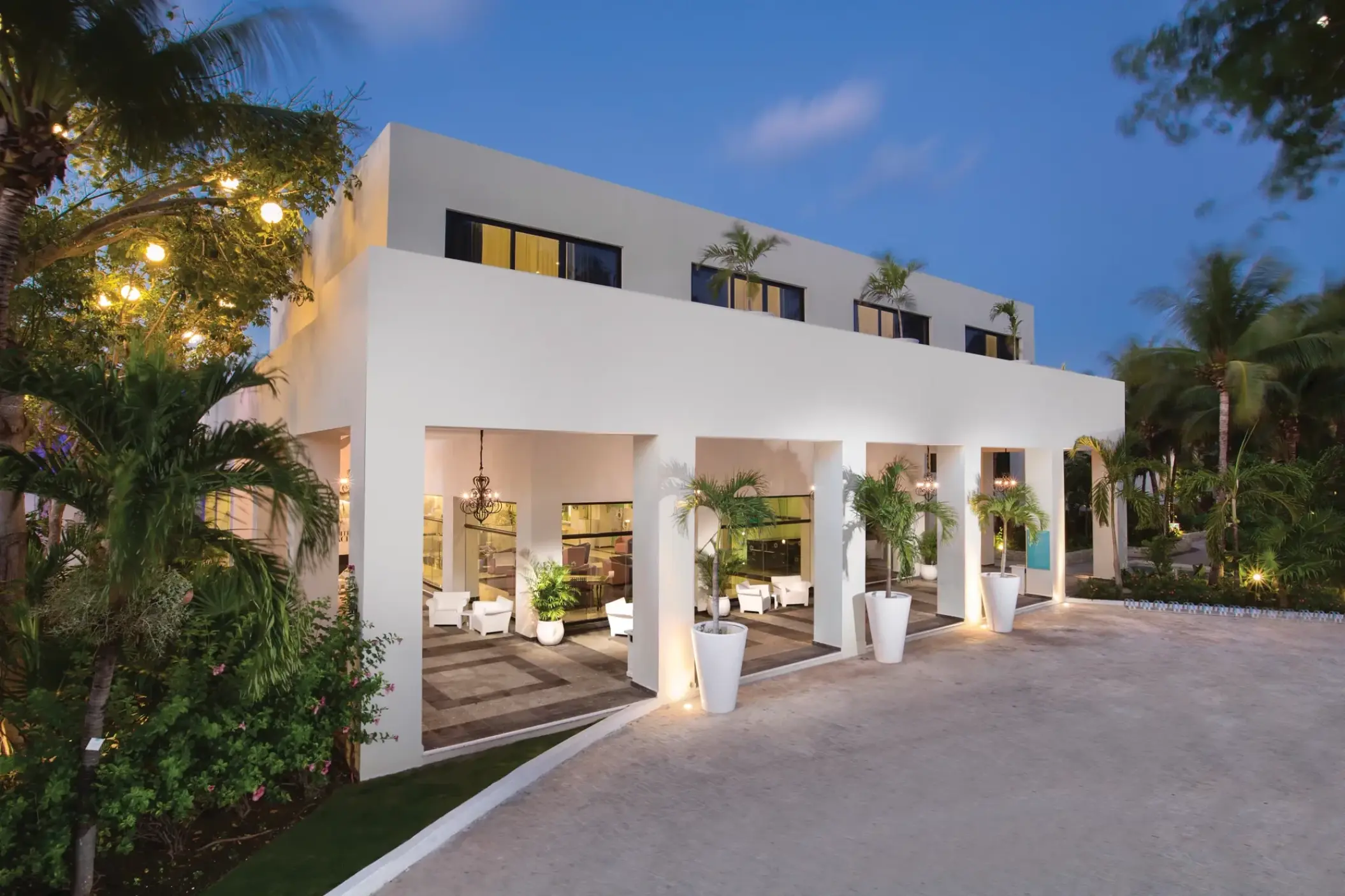 White modern building facade and entryway at Sunscape Akumal, Tulum