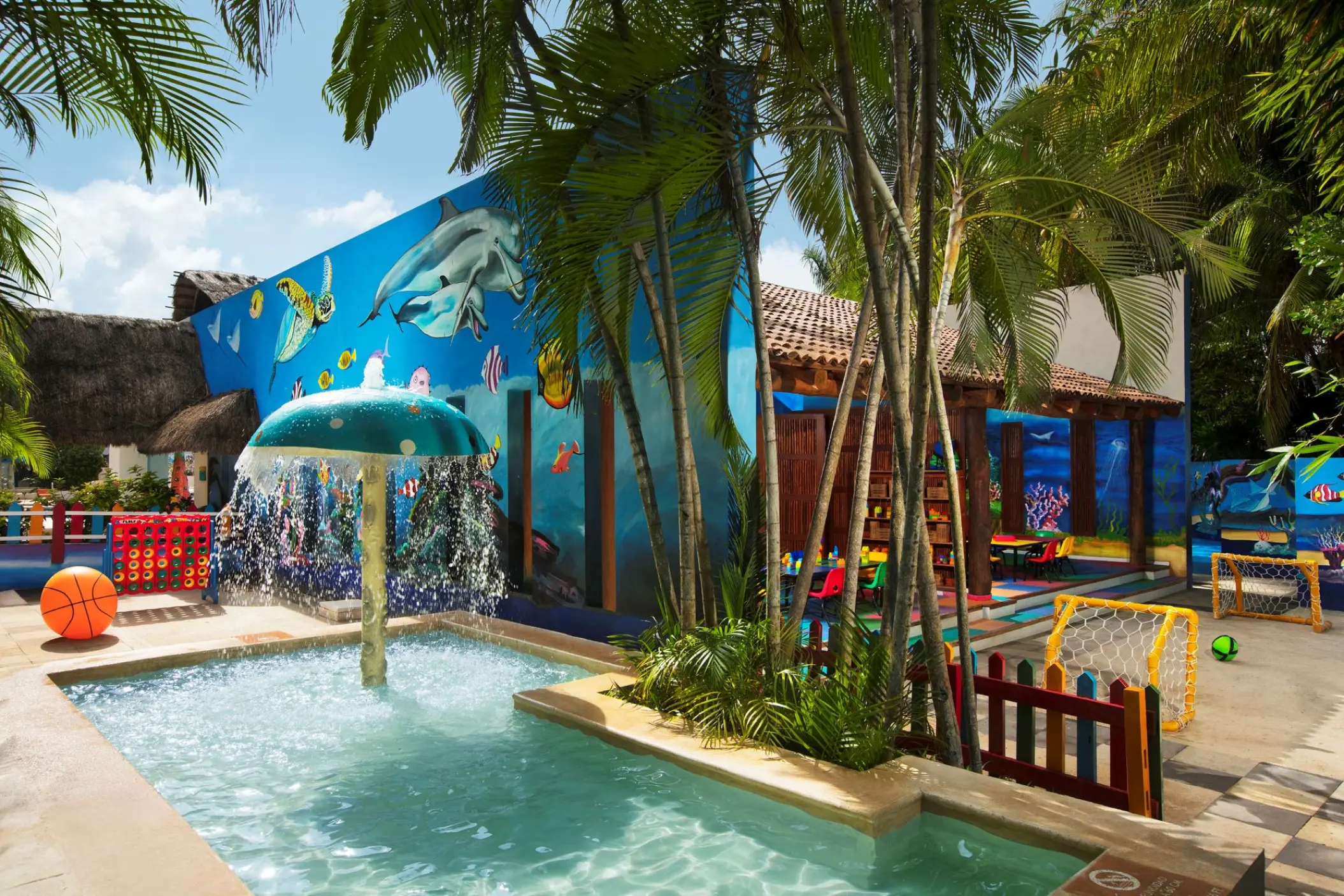 Kids water park and splash pool with a mushroom fountain at Sunscape Akumal Beach, Tulum