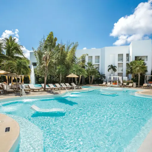 Sunscape Akumal swimming pool with lounge chairs and cabanas, Tulum