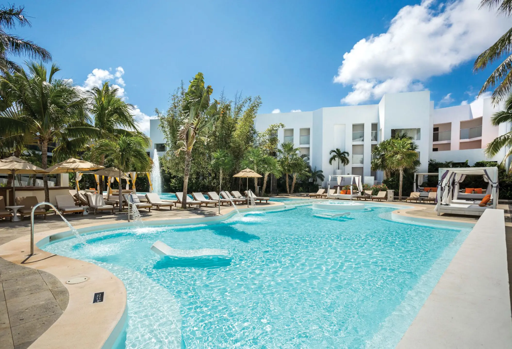 Sunscape Akumal swimming pool with lounge chairs and cabanas, Tulum