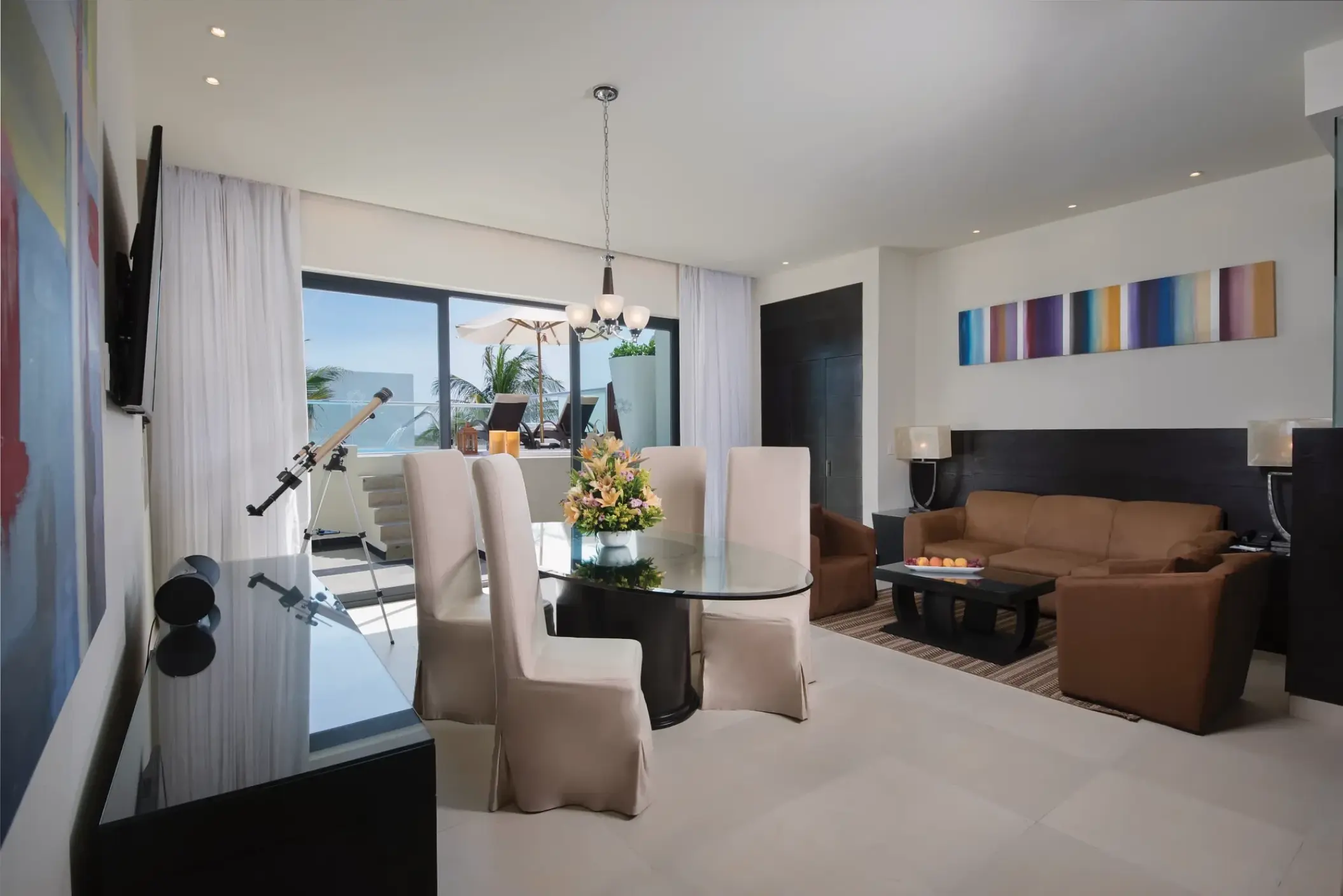 Presidential Suite living and dining area with private balcony at Sunscape Akumal, Tulum