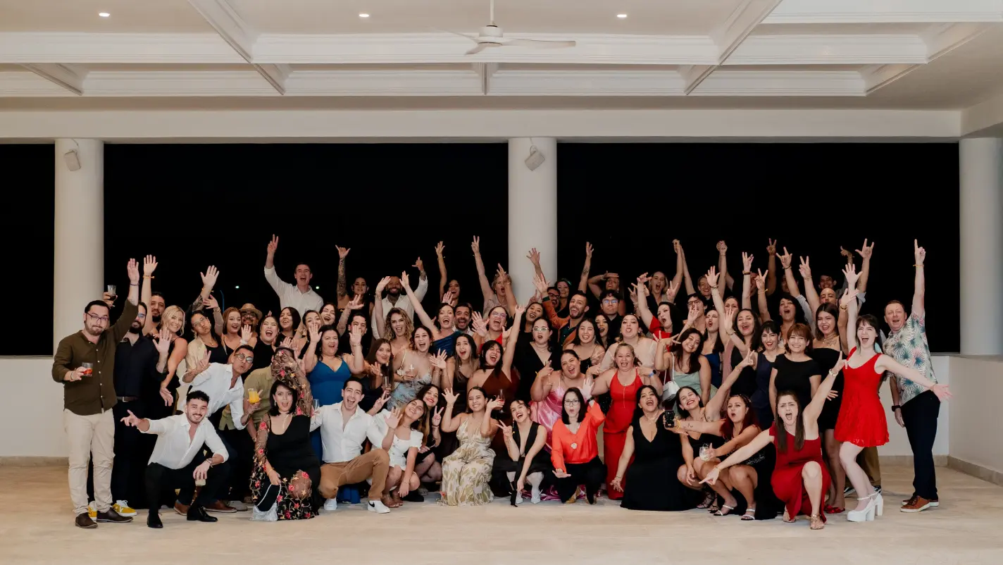 Paradise Weddings team members smiling and cheering during a group celebration