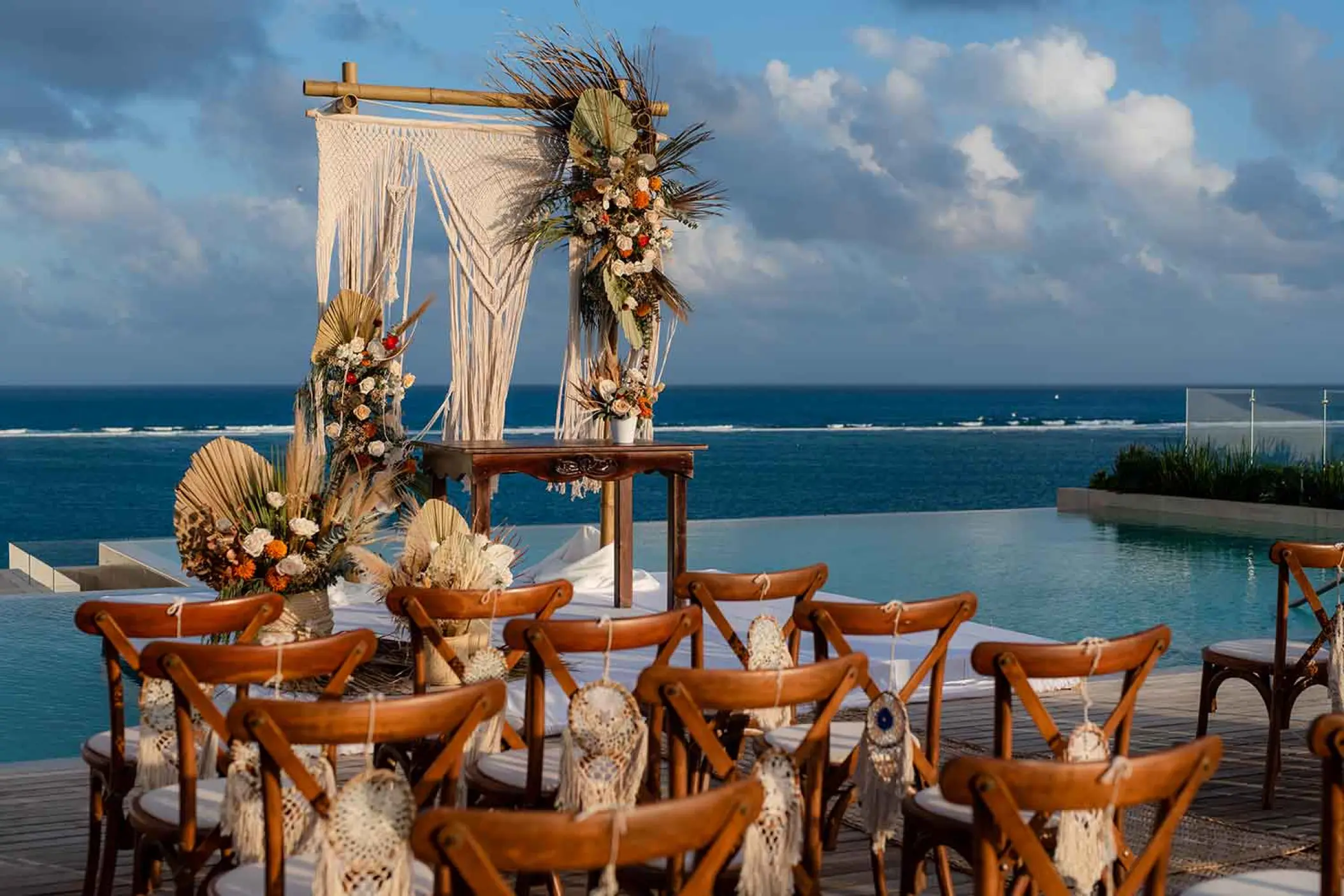 Rooftop wedding ceremony with macrame arch and ocean views at The Fives Oceanfront, Riviera Maya