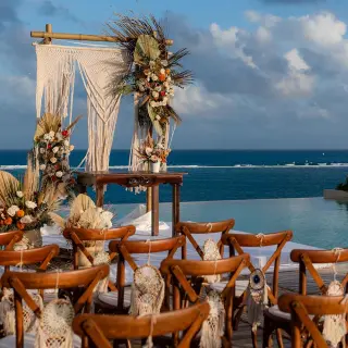 Rooftop wedding ceremony with macrame arch and ocean views at The Fives Oceanfront, Riviera Maya