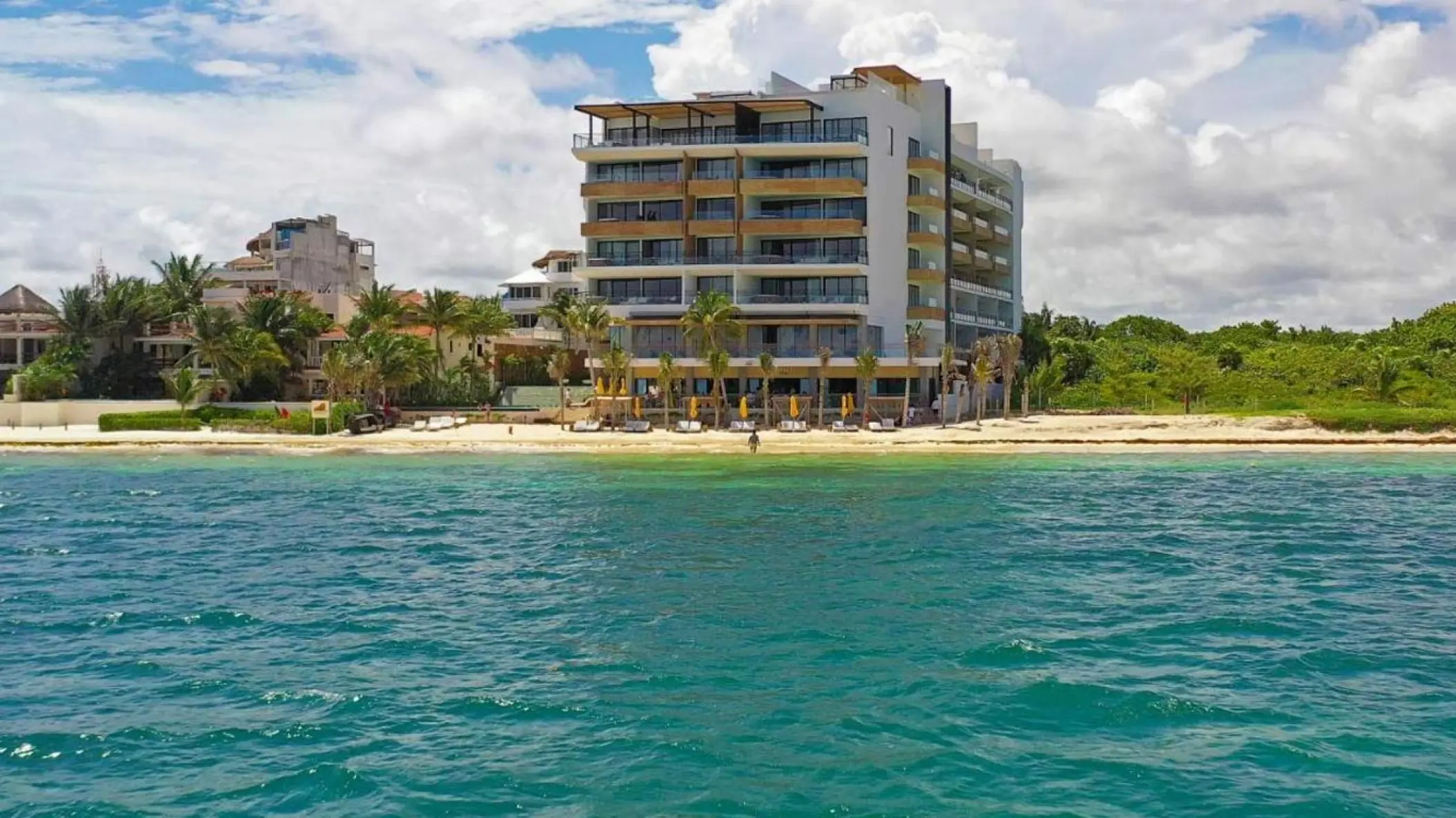 The Fives Oceanfront residential suites and beachfront viewed from the turquoise Caribbean Sea, Riviera Maya