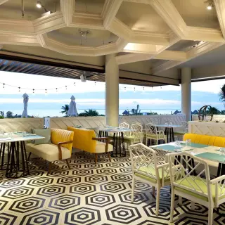 Indoor seating at TRS Coral beach club with geometric tile flooring and ocean views, Cancun