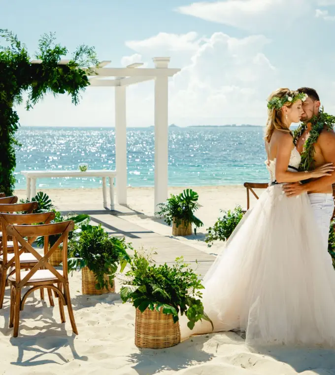 The bride and groom embracing at a beach ceremony at TRS Coral Hotel, Cancun