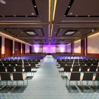 TRS Coral Hotel convention center with rows of seating and purple lighting, Cancun