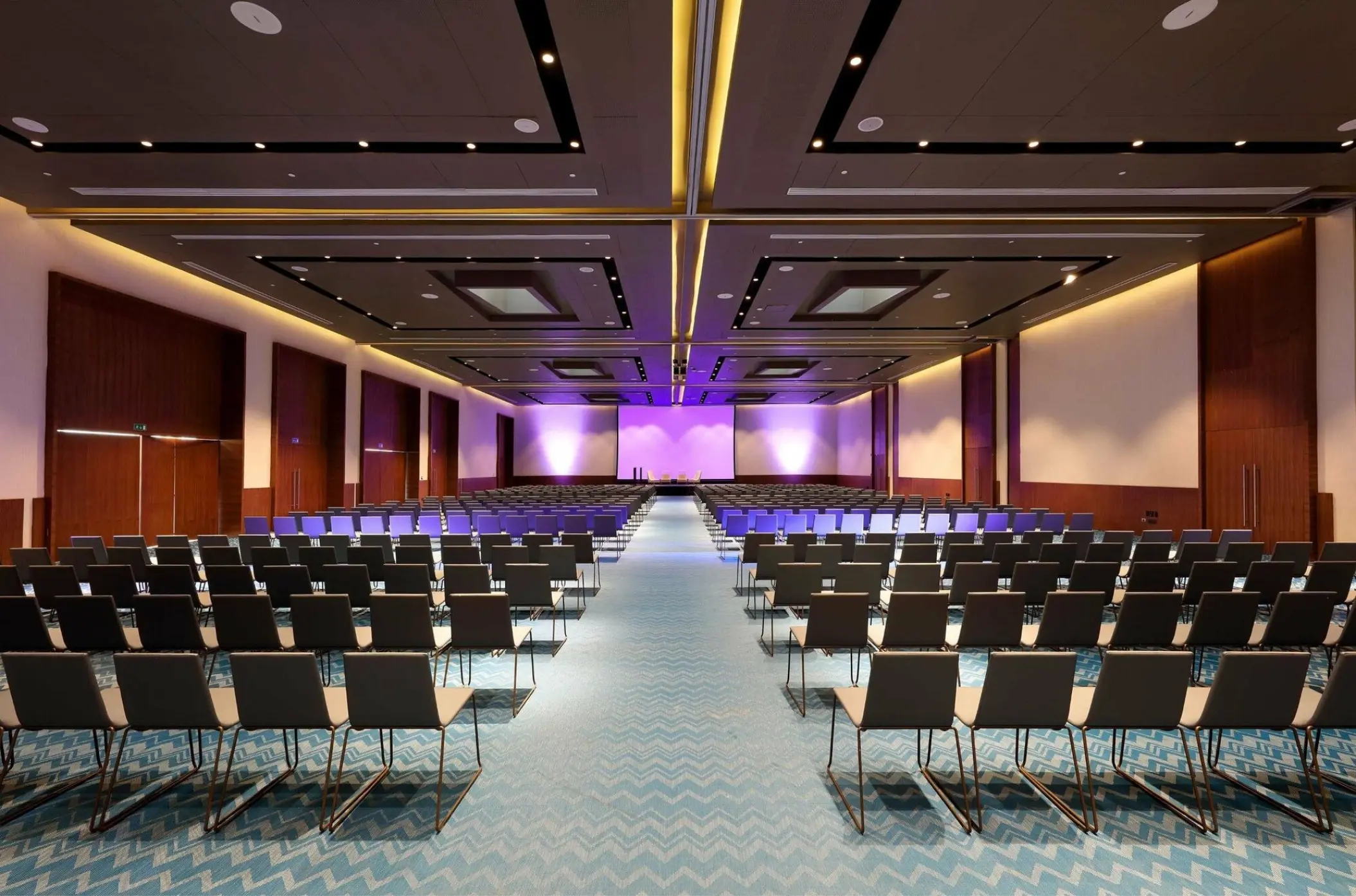 TRS Coral Hotel convention center with rows of seating and purple lighting, Cancun