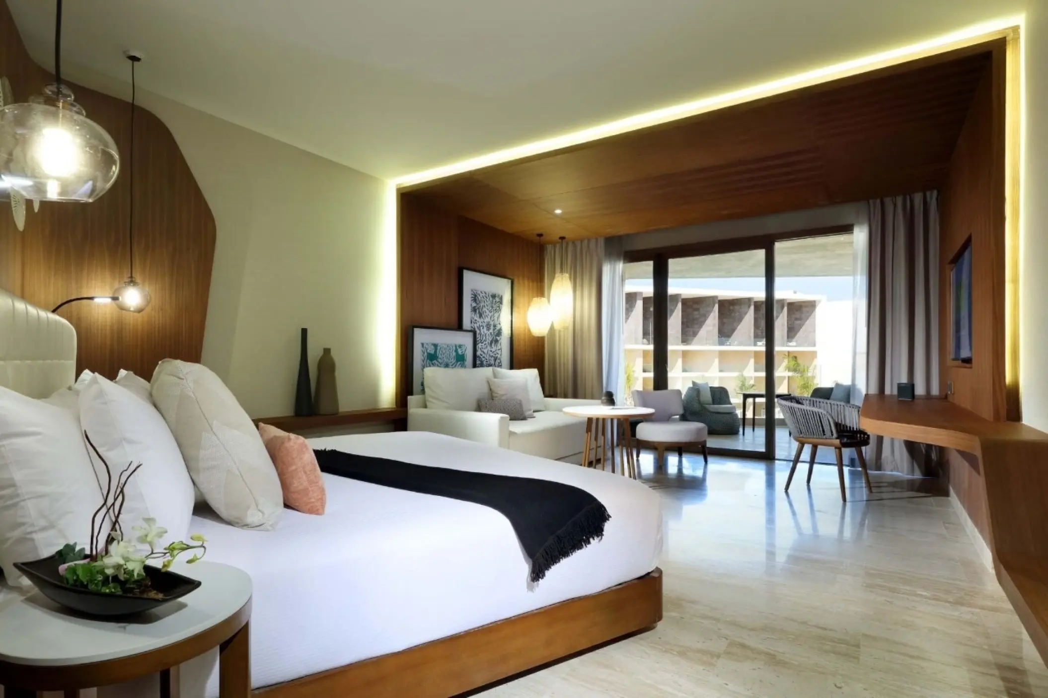 Junior Suite with a white sofa and modern wood accents at TRS Coral Hotel, Cancun