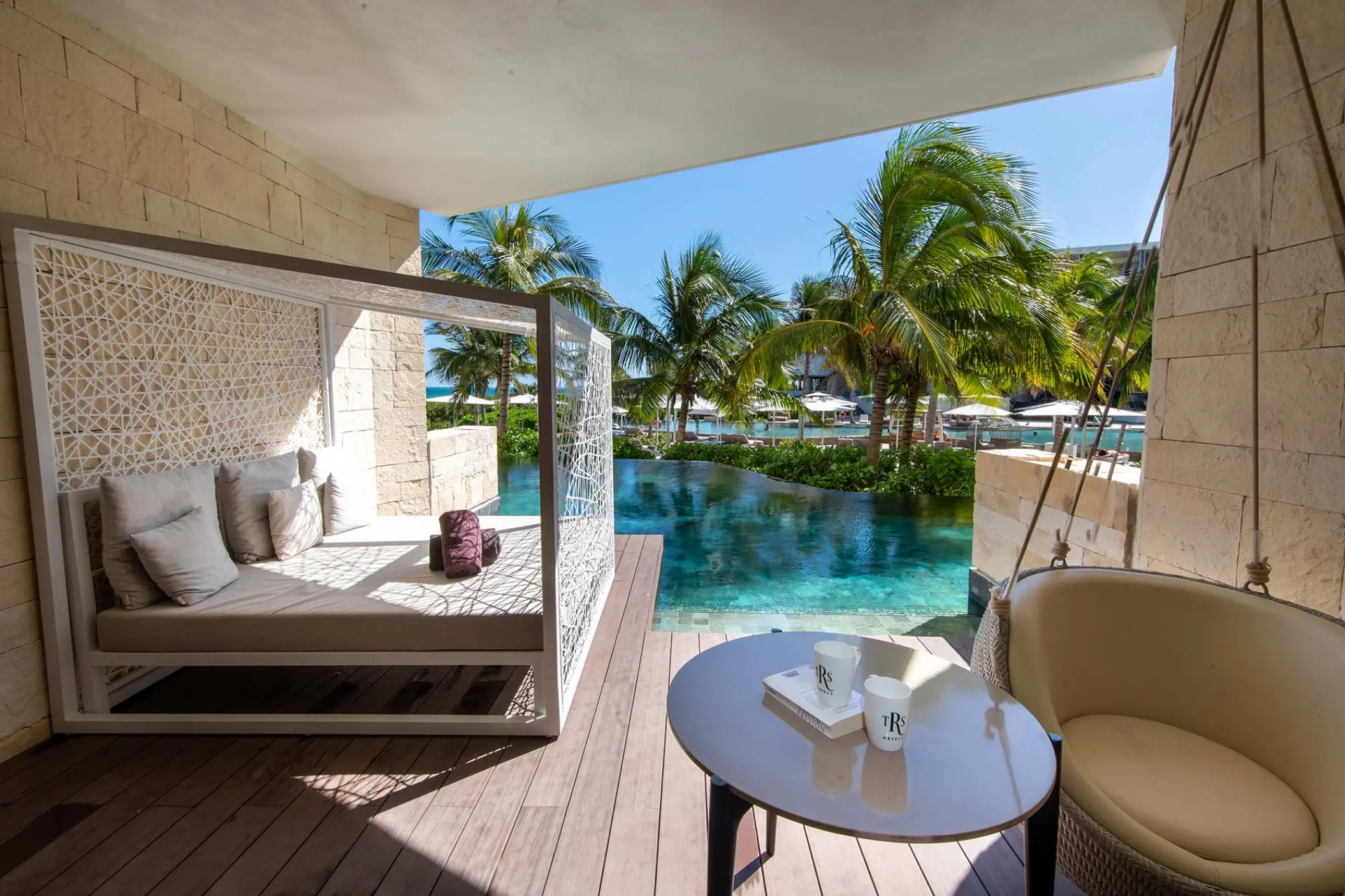 Junior suite swim-up terrace with daybed and pool access at TRS Coral Hotel, Cancun