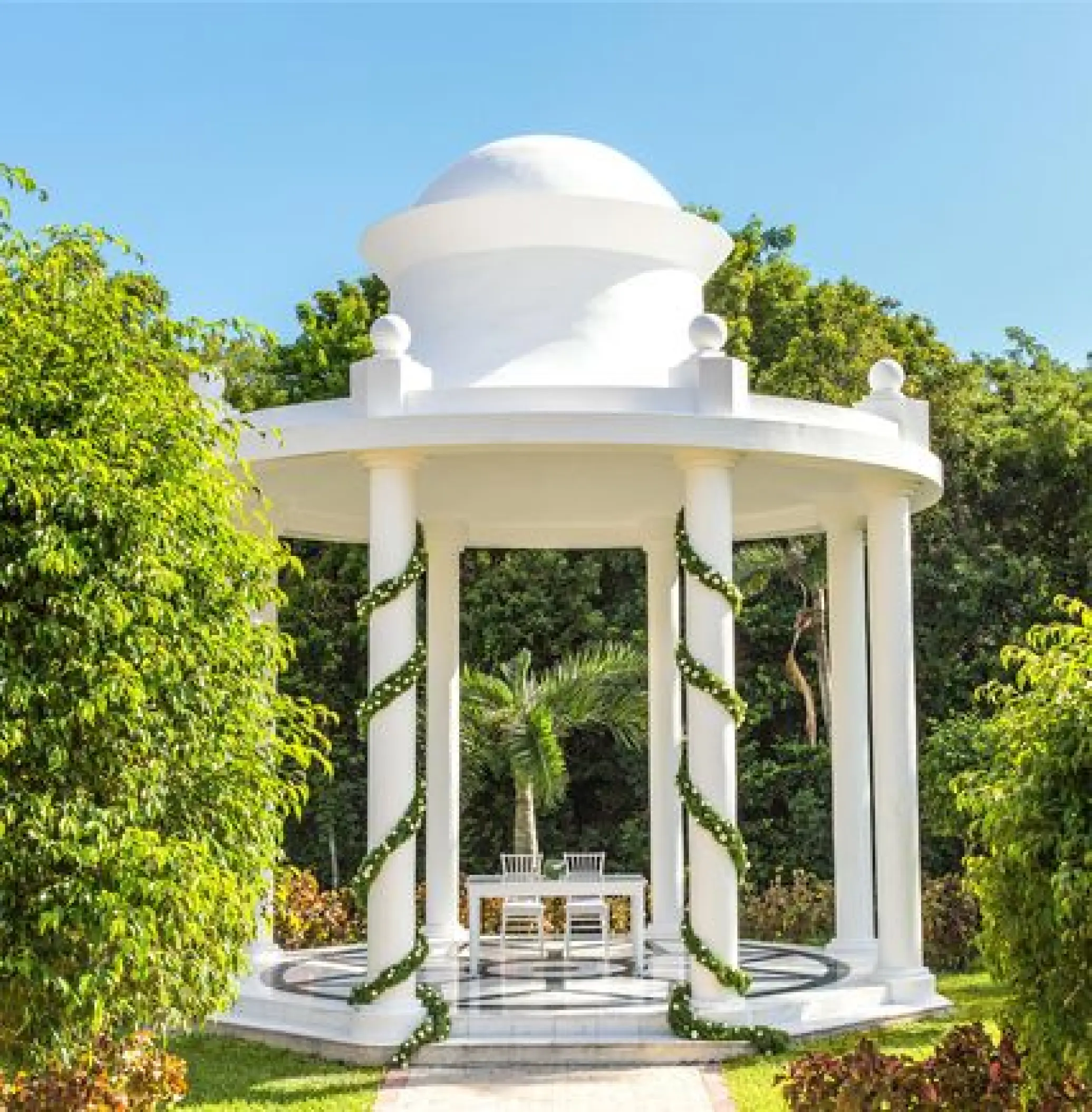White garden gazebo wedding ceremony setup at TRS Coral Hotel, Cancun