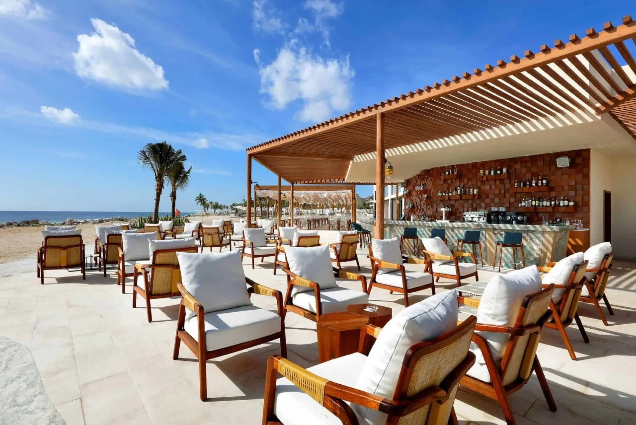 Outdoor lounge and beach bar under a wooden pergola at TRS Yucatan, Riviera Maya