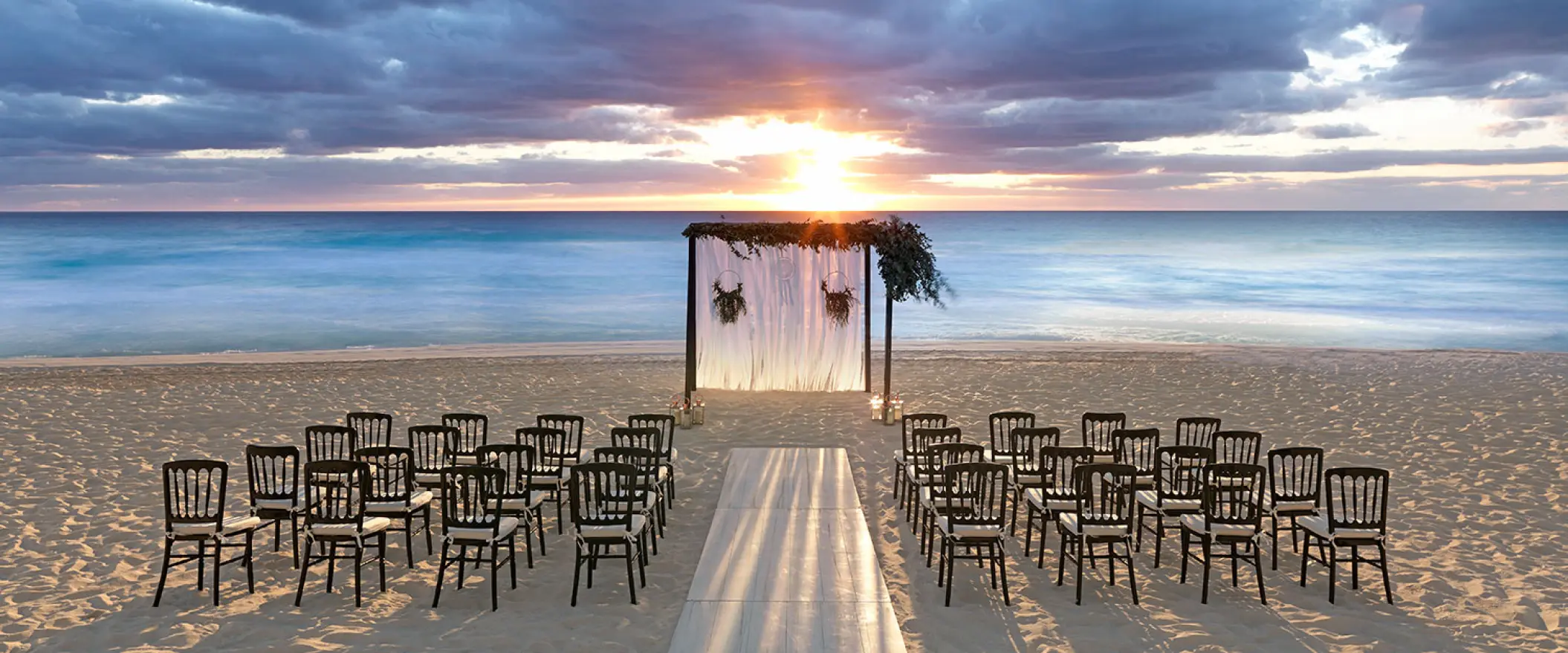 Beachfront wedding ceremony setup at sunset at UNICO 20°87°, Riviera Maya