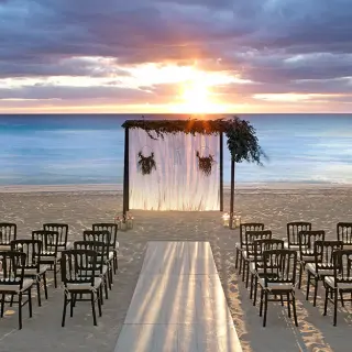 Beachfront wedding ceremony setup at sunset at UNICO 20°87°, Riviera Maya