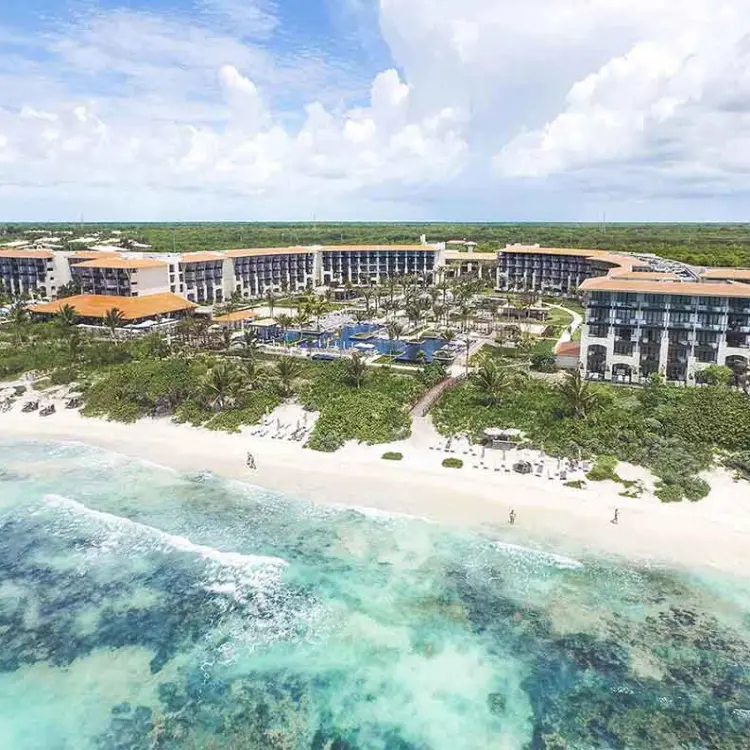 Aerial view of UNICO 20°87° Riviera Maya grounds and white sand beach