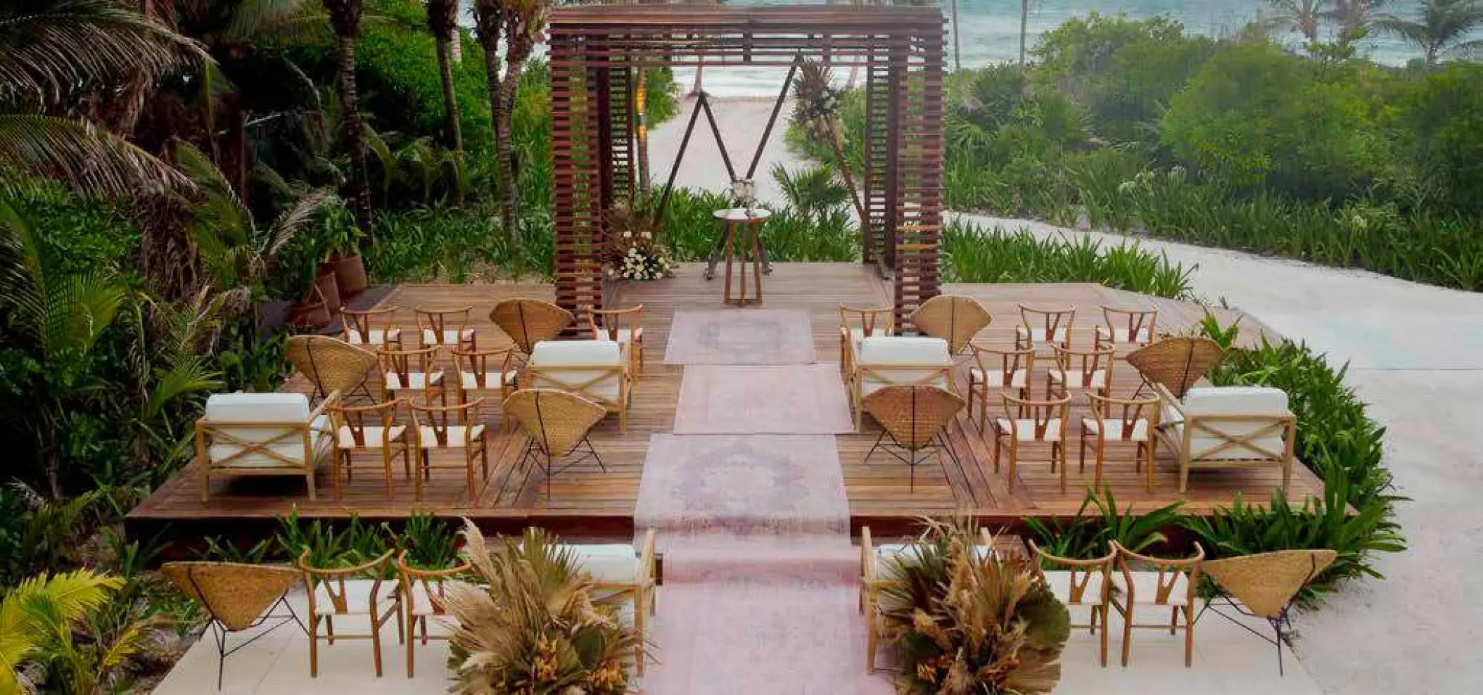 Wooden gazebo wedding ceremony setup with boho-style chairs at UNICO 20°87°, Riviera Maya
