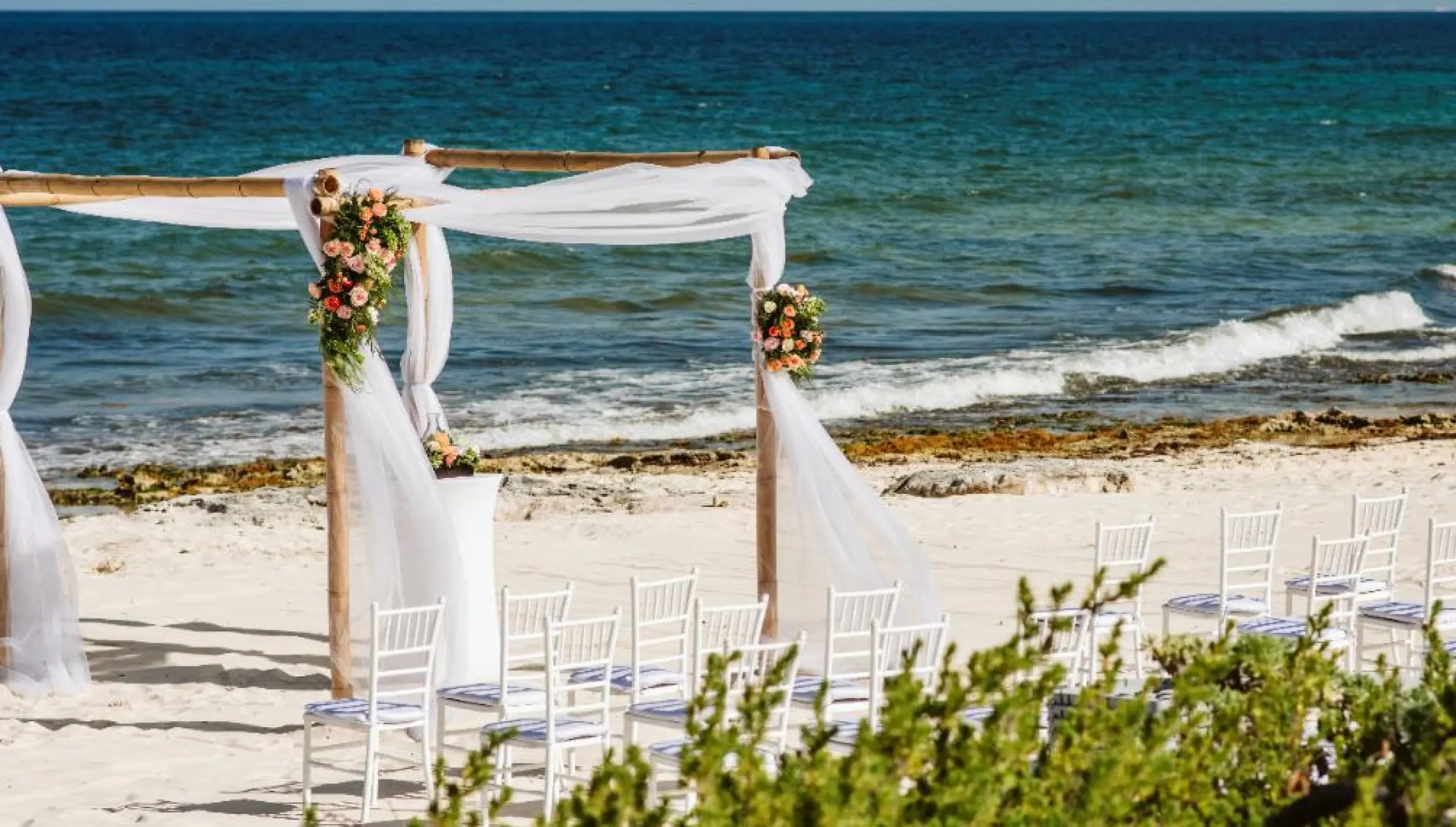 Ceremony decor on the beach wedding venue at Valentin Imperial Riviera Maya