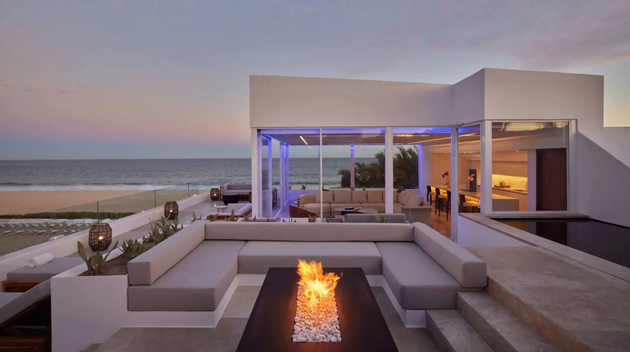 Viceroy Los Cabos oceanfront villa terrace with a fire pit at dusk, Cabo San Lucas