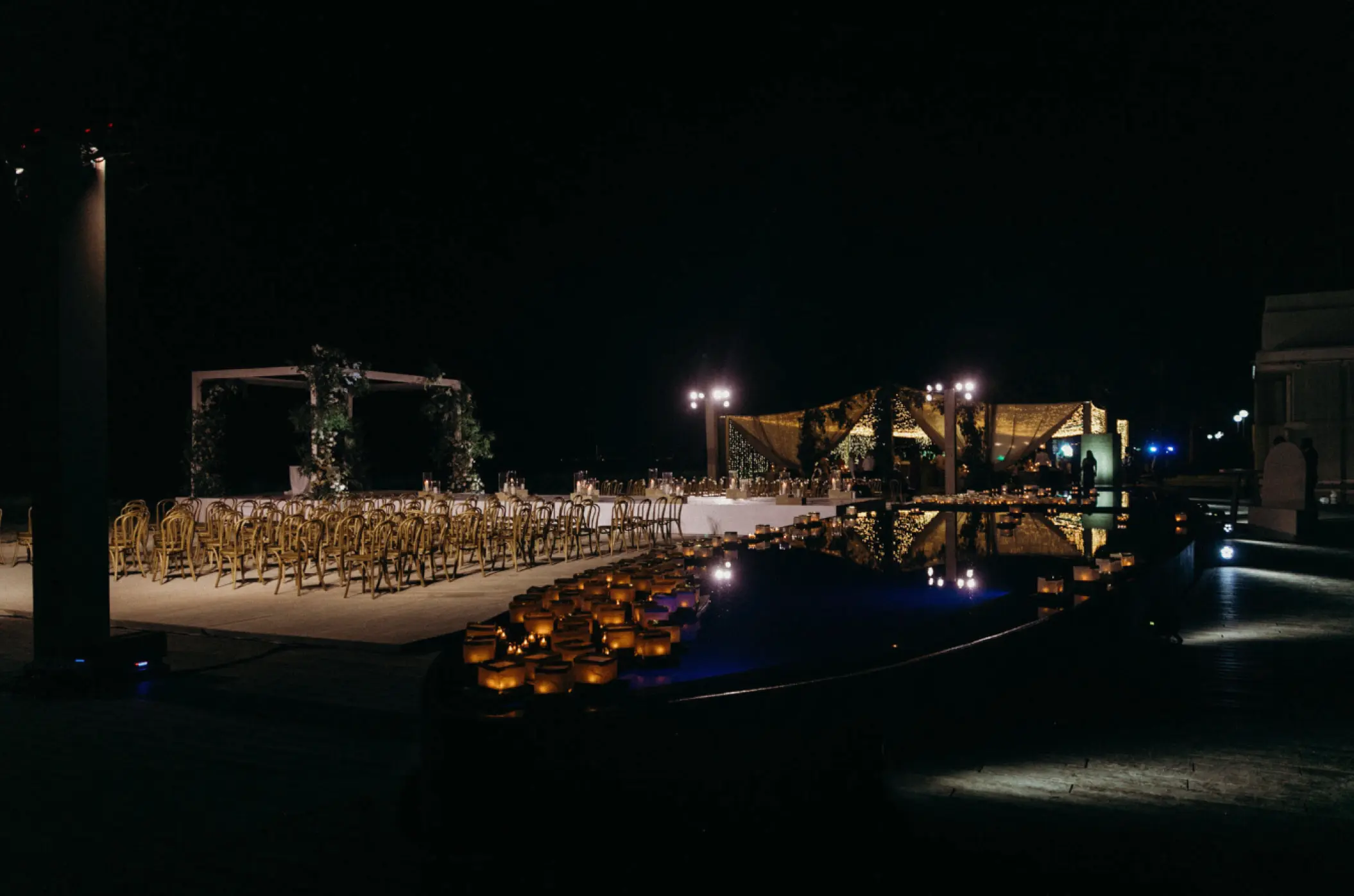 Nighttime beach ceremony setup with lantern-lined pool at Viceroy Los Cabos, Cabo San Lucas