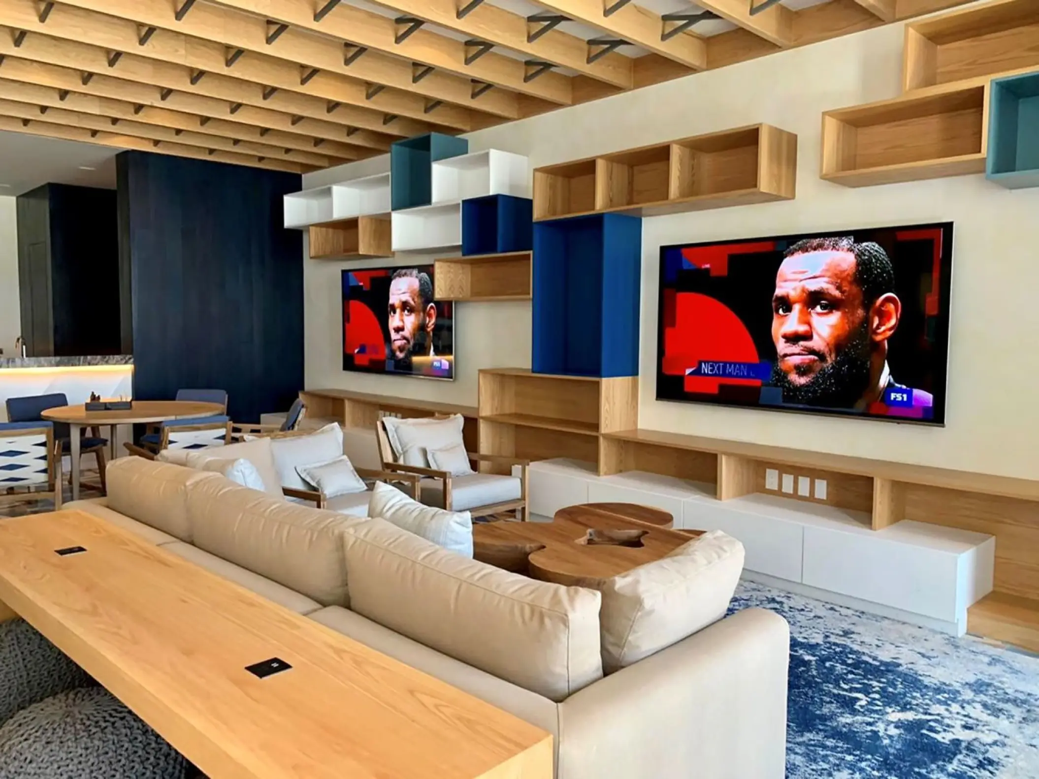 Modern game room with large TVs and lounge seating at Viceroy Los Cabos, Cabo San Lucas