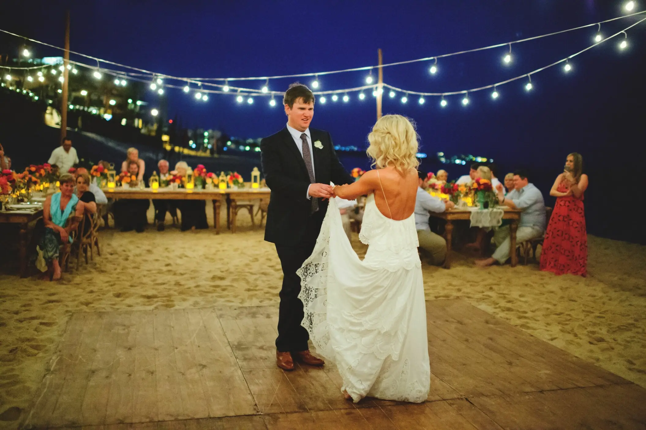 The couple's first dance at a beach reception with string lights at Villa La Estancia Los Cabos, Cabo San Lucas