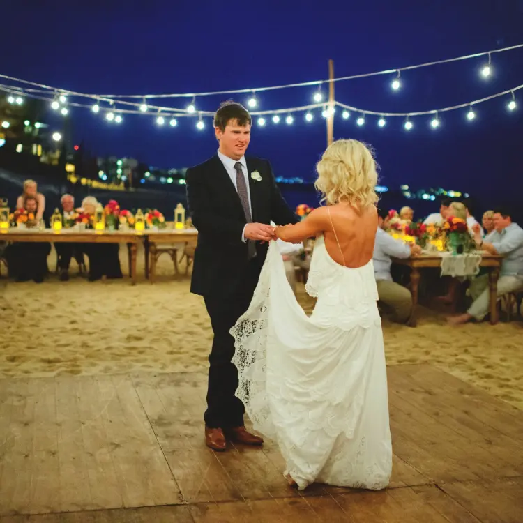 The couple's first dance at a beach reception with string lights at Villa La Estancia Los Cabos, Cabo San Lucas
