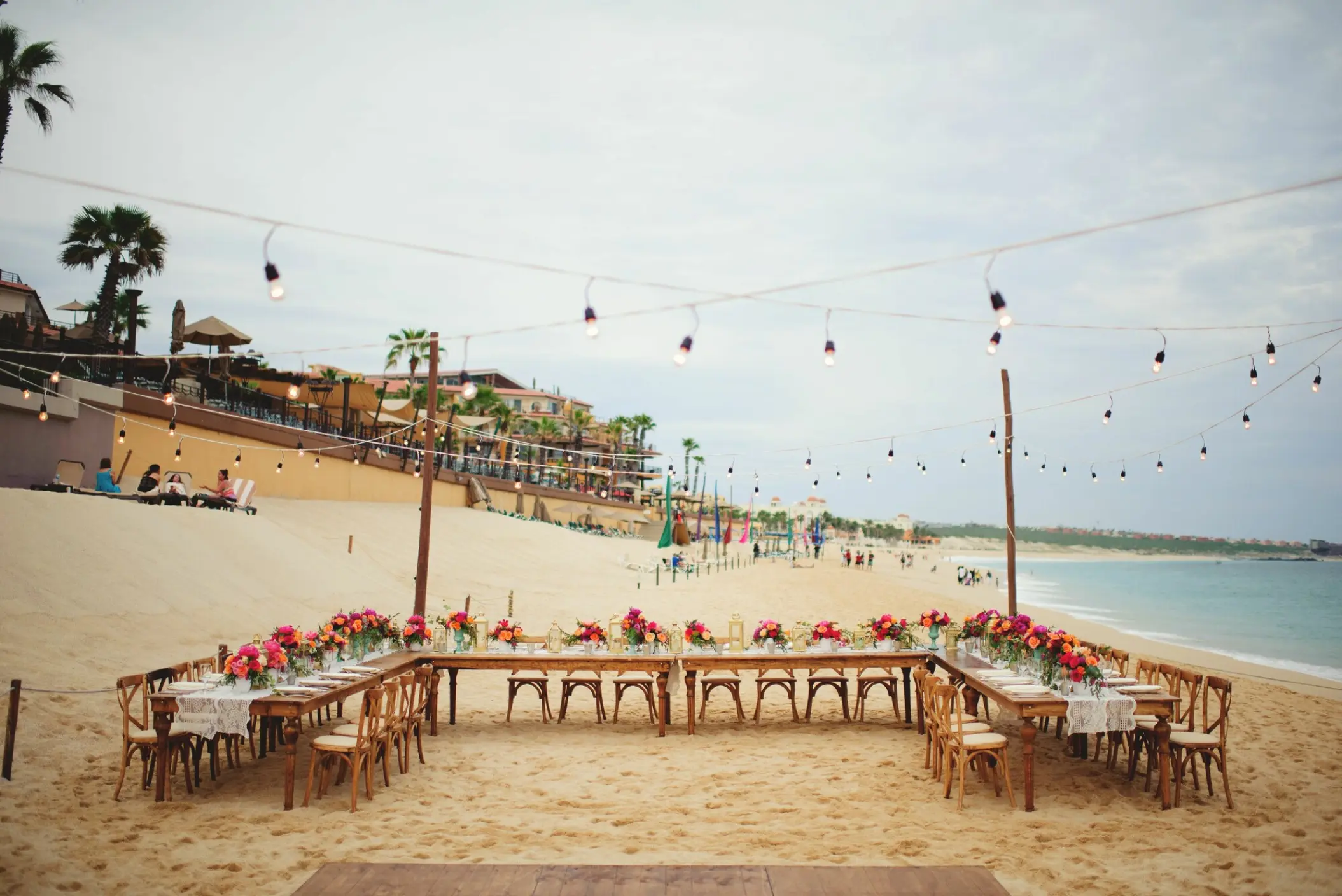 Beachfront wedding reception setup with string lights at Villa La Estancia, Cabo San Lucas