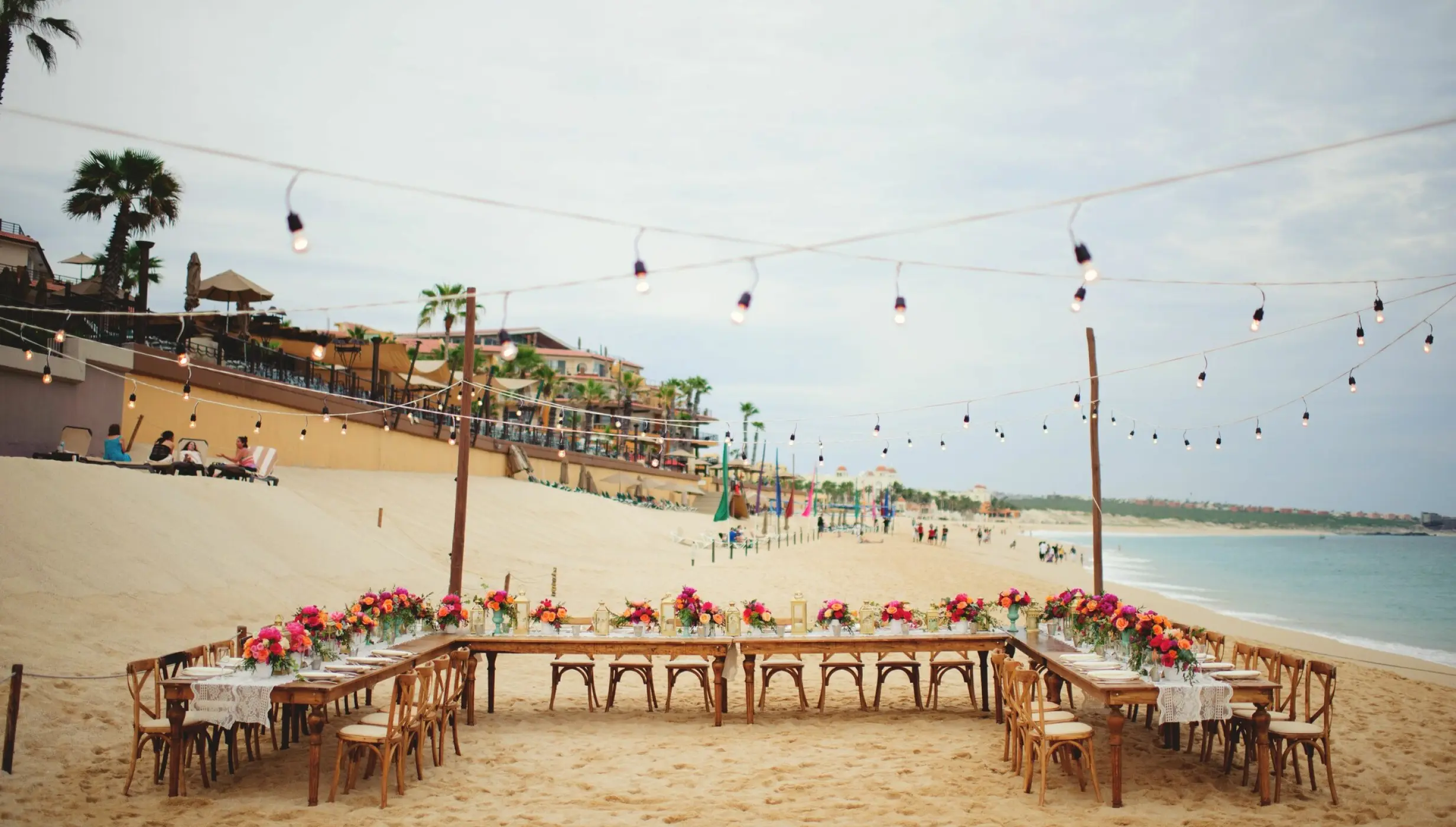 Dinner reception decor on the beach wedding venue at Villa La Estancia Los Cabos