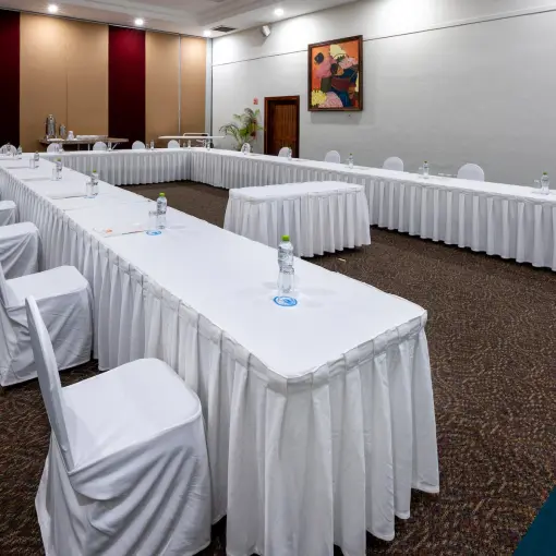 Indoor wedding reception ballroom setup with long tables at Viva Maya by Wyndham, Playa Del Carmen
