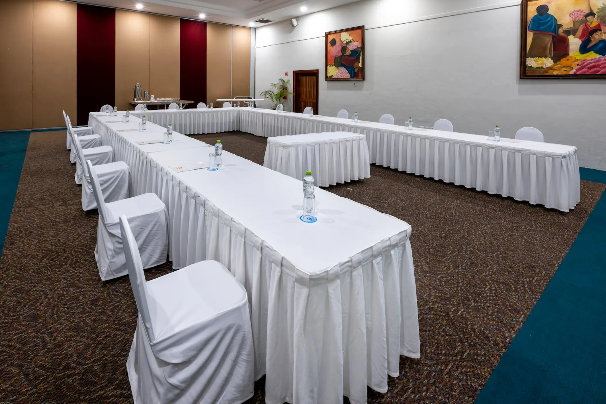 Indoor wedding reception ballroom setup with long tables at Viva Maya by Wyndham, Playa Del Carmen