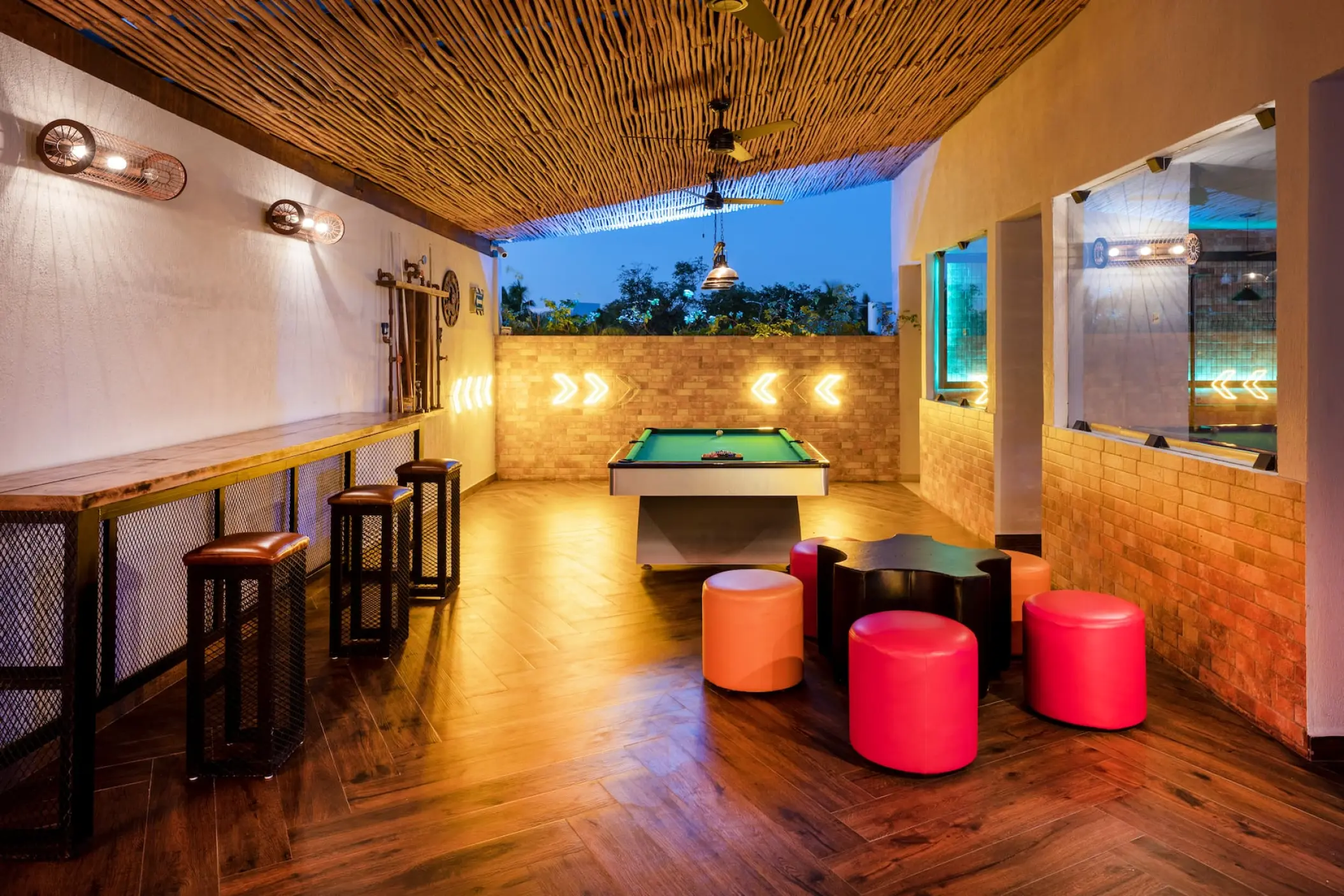 Game room with a pool table and colorful stools at Viva Maya, Playa Del Carmen