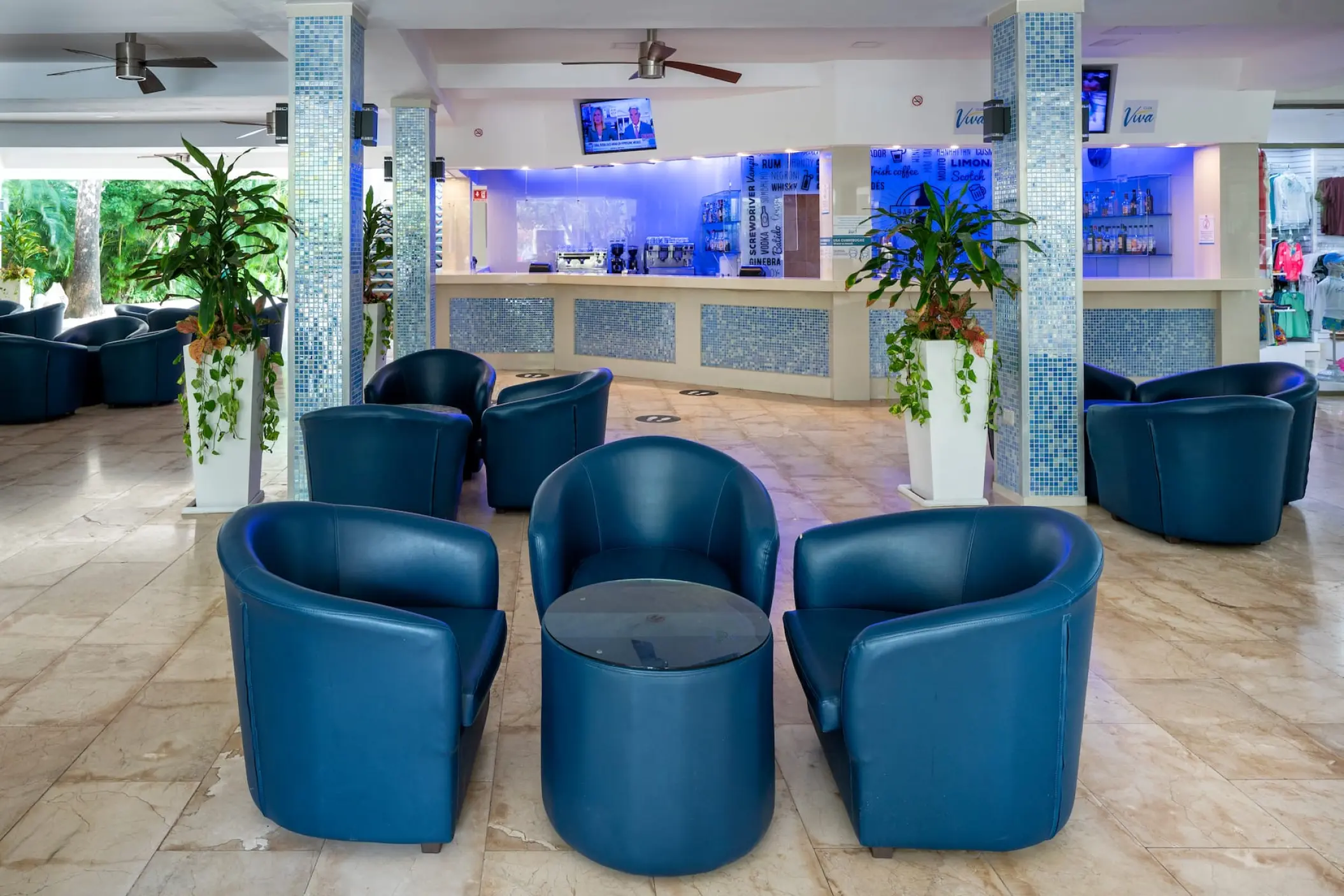 Modern lobby lounge with blue leather armchairs at Viva Maya by Wyndham, Playa Del Carmen