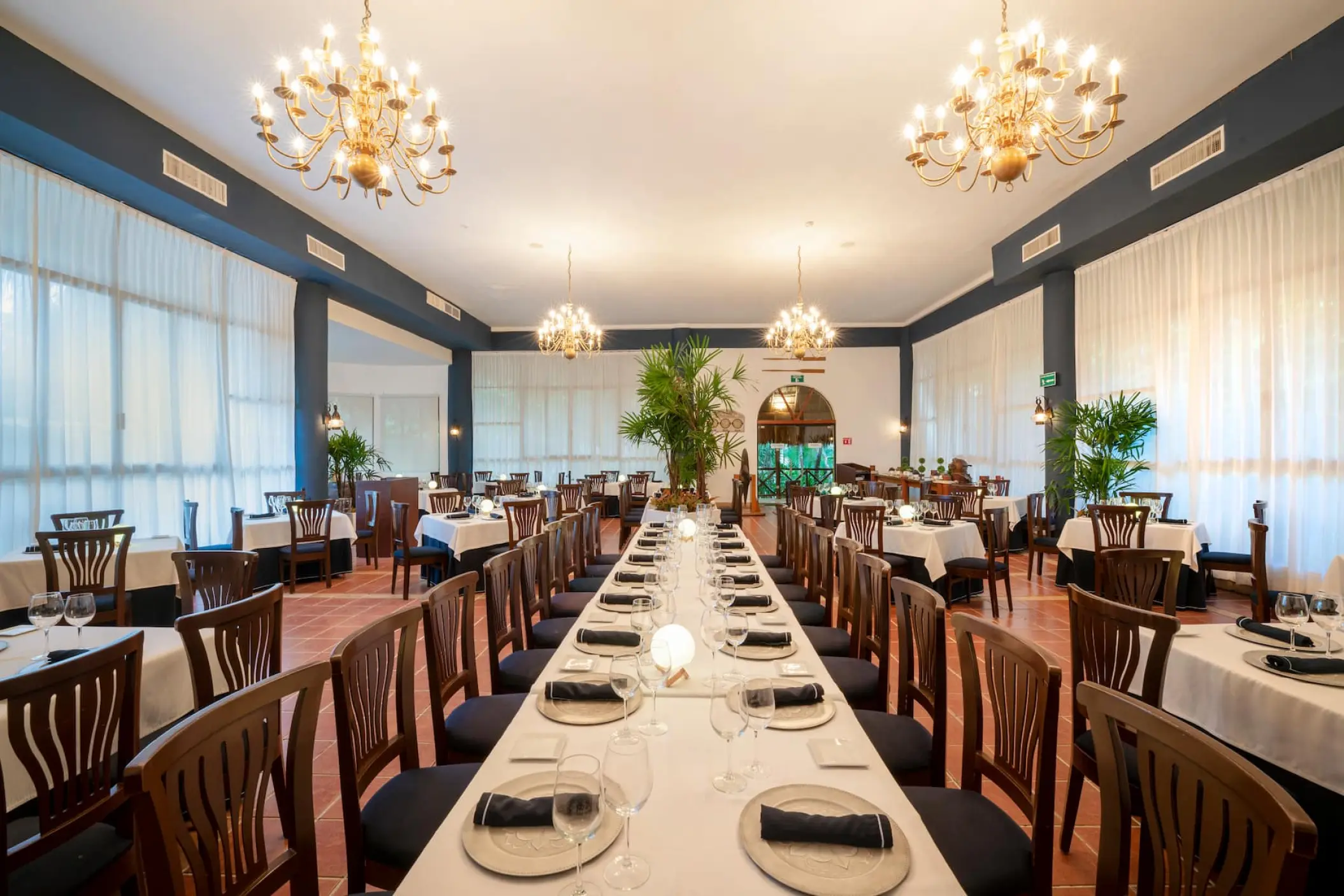Viva Maya by Wyndham restaurant dining room with long tables and chandeliers, Playa Del Carmen