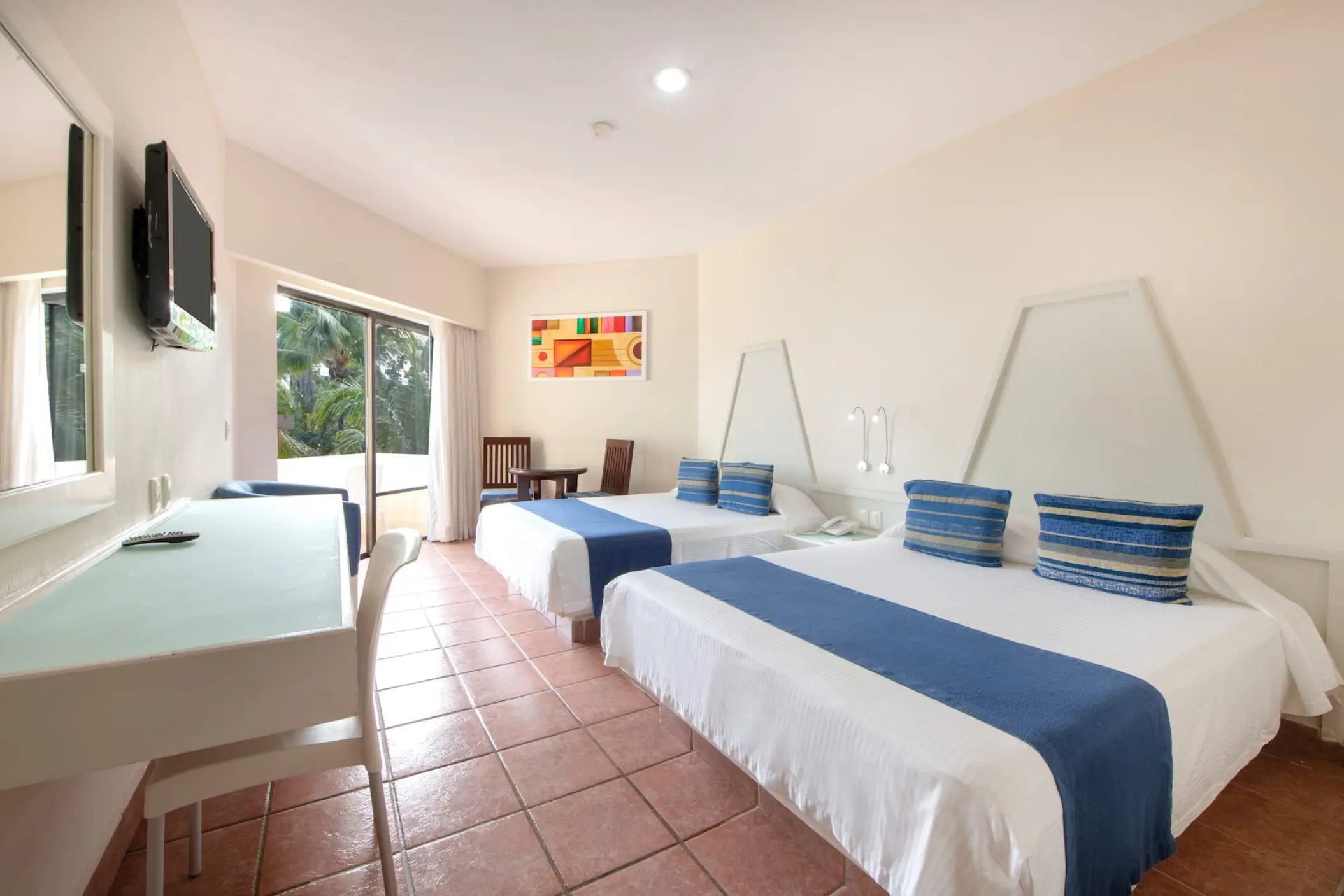 Modern double guest room with blue accents at Viva Maya by Wyndham, Playa Del Carmen