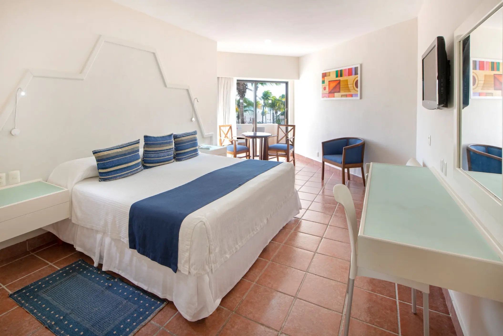 Modern hotel suite with blue accents and tile flooring at Viva Maya by Wyndham, Playa Del Carmen