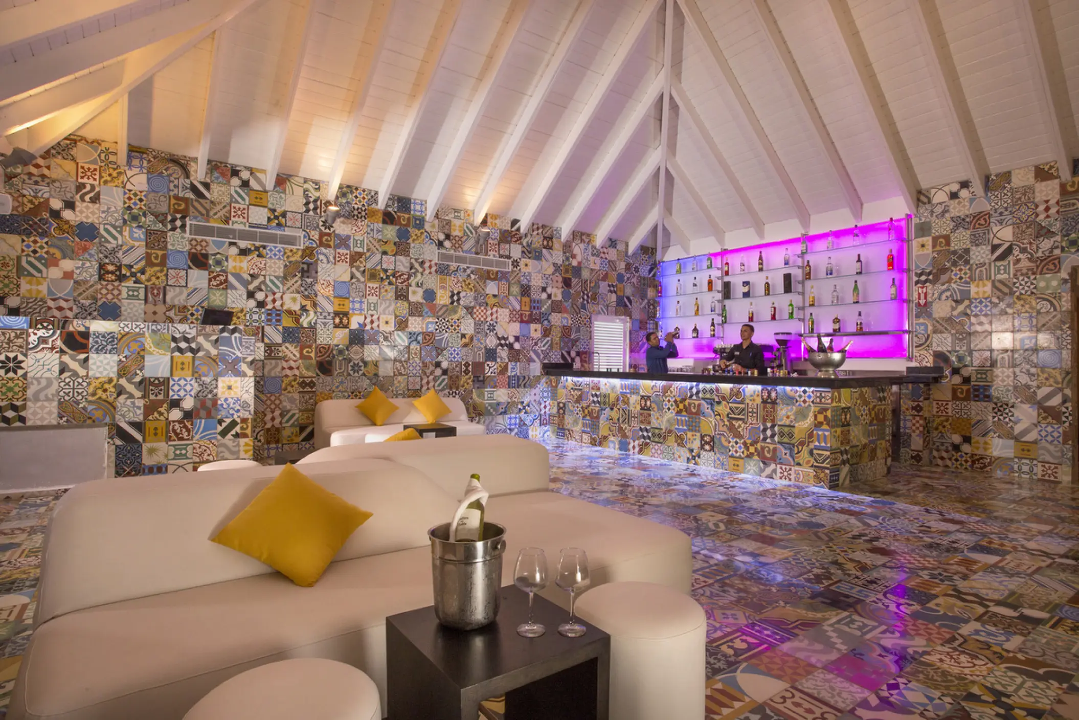 Indoor bar and lounge with vibrant patterned tiles at Viva V Samana, Samana
