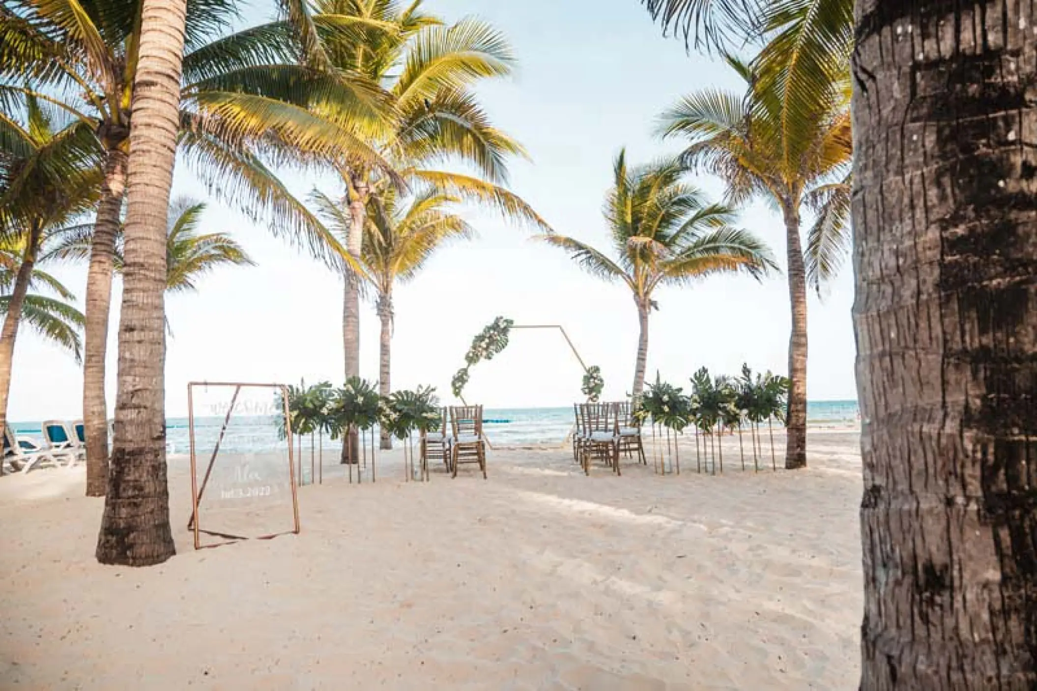 Beachfront wedding ceremony setup with a hexagonal arch at Viva V Samana, Samana