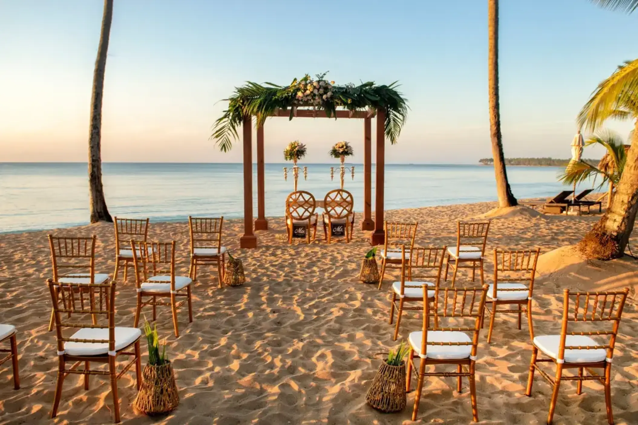 Beachfront wedding ceremony with a floral wooden huppah at Viva V Samana, Samana