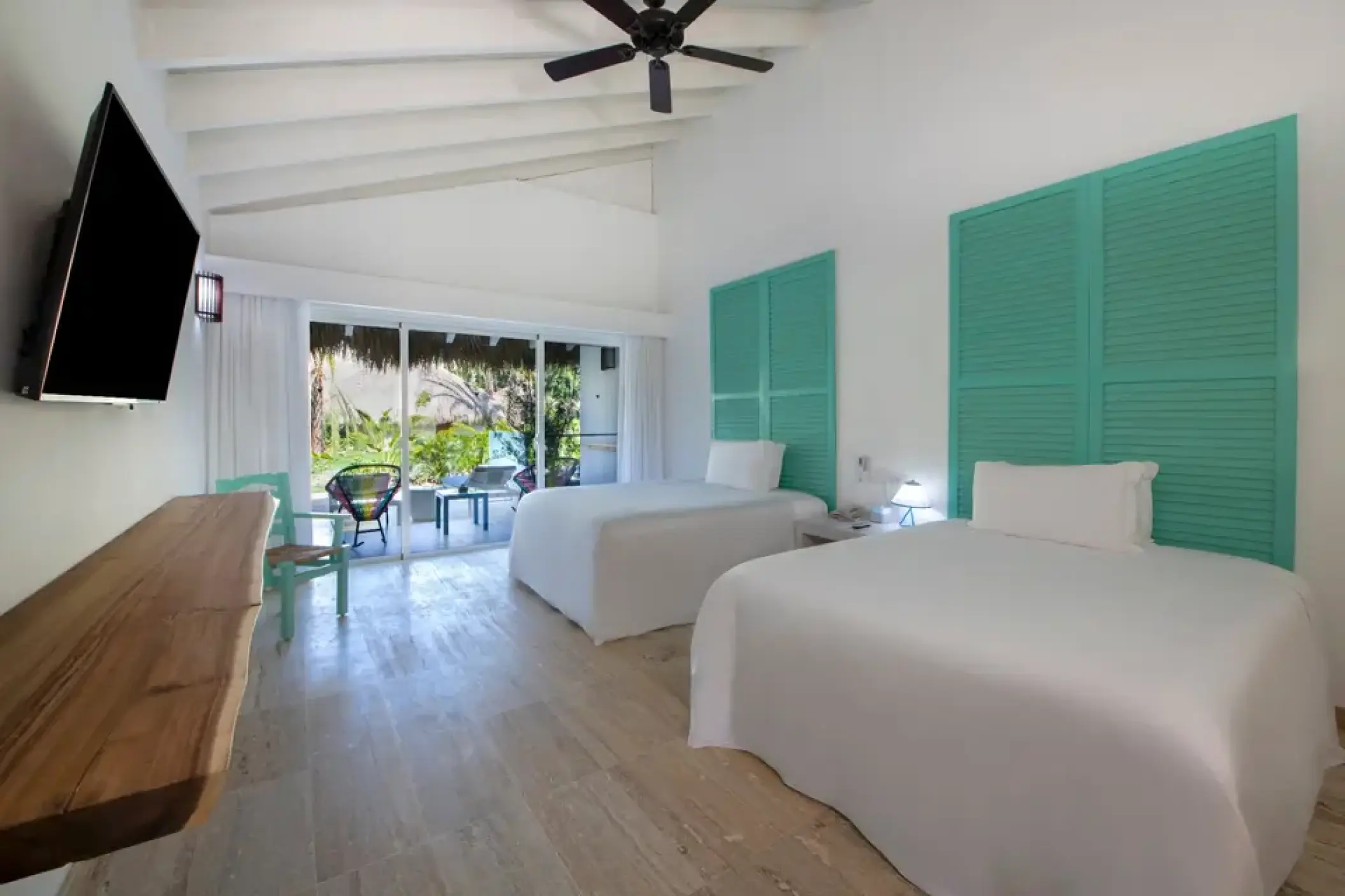 Bungalow room with two beds and teal headboards at Viva V Samana, Samana
