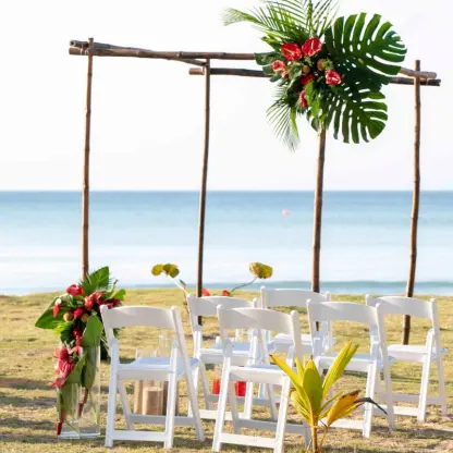 Wooden beach ceremony arch with tropical greenery at Viva V Samana, Samana