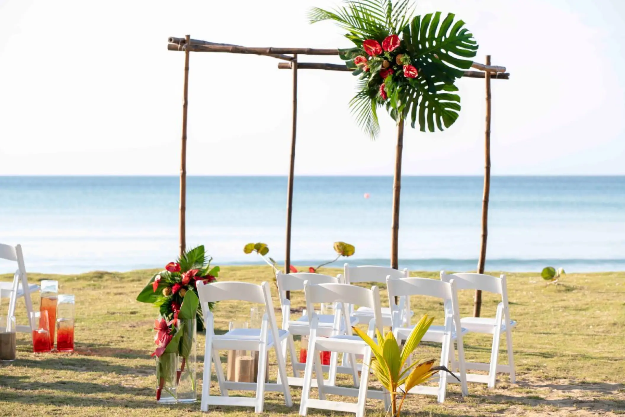 Wooden beach ceremony arch with tropical greenery at Viva V Samana, Samana