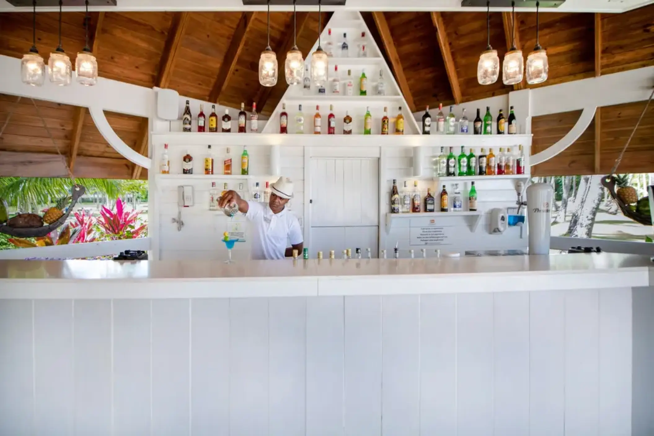 Bartender preparing a cocktail at the white juice bar at Viva V Samana, Samana