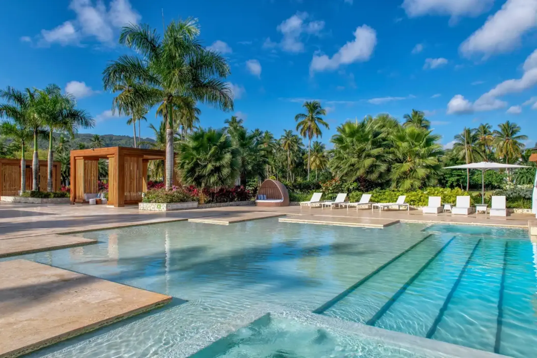 Main pool and lounge area surrounded by palm trees at Viva V Samana, Samana