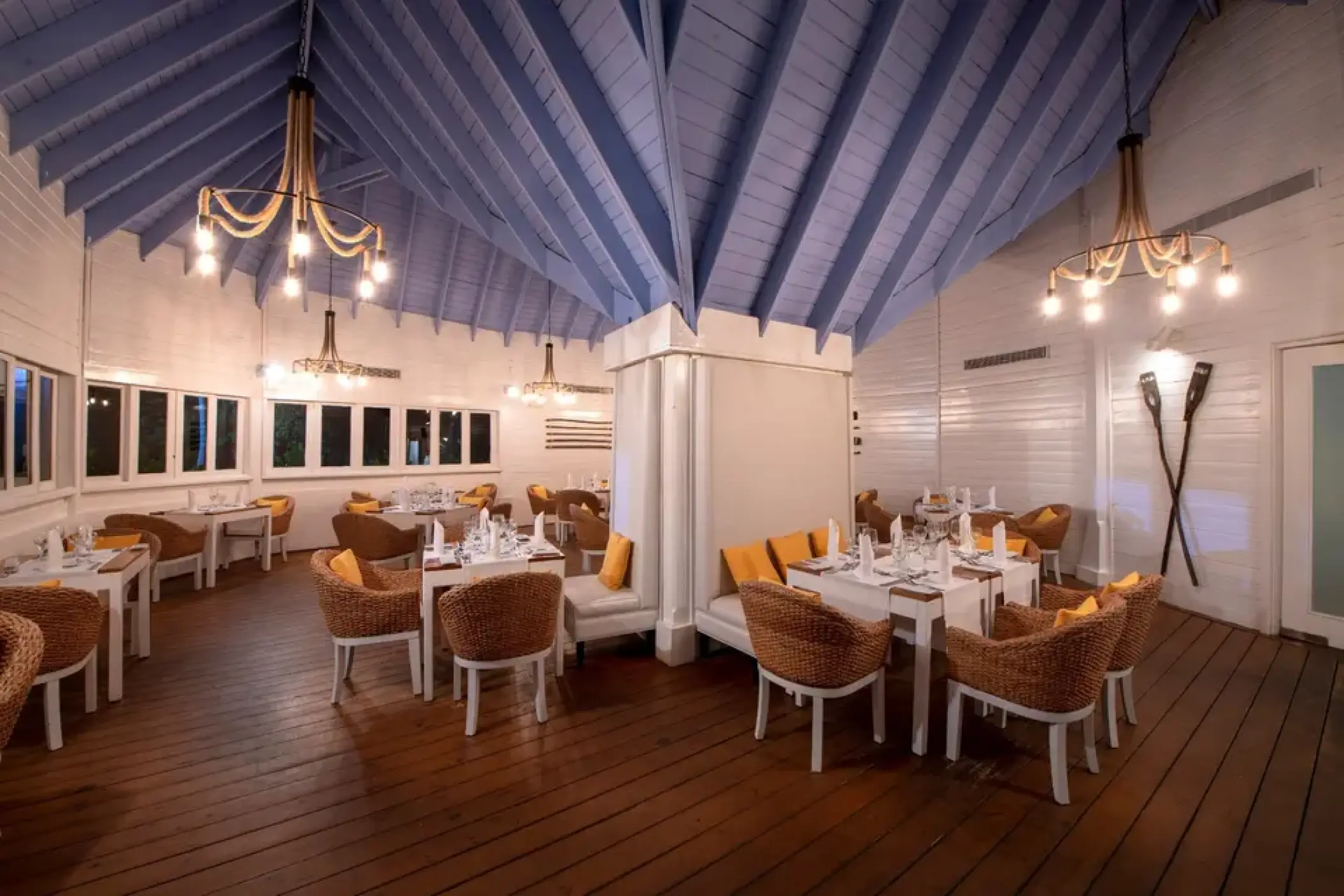 Mar y Fuego restaurant with wicker seating and blue vaulted ceiling at Viva V Samana, Samana