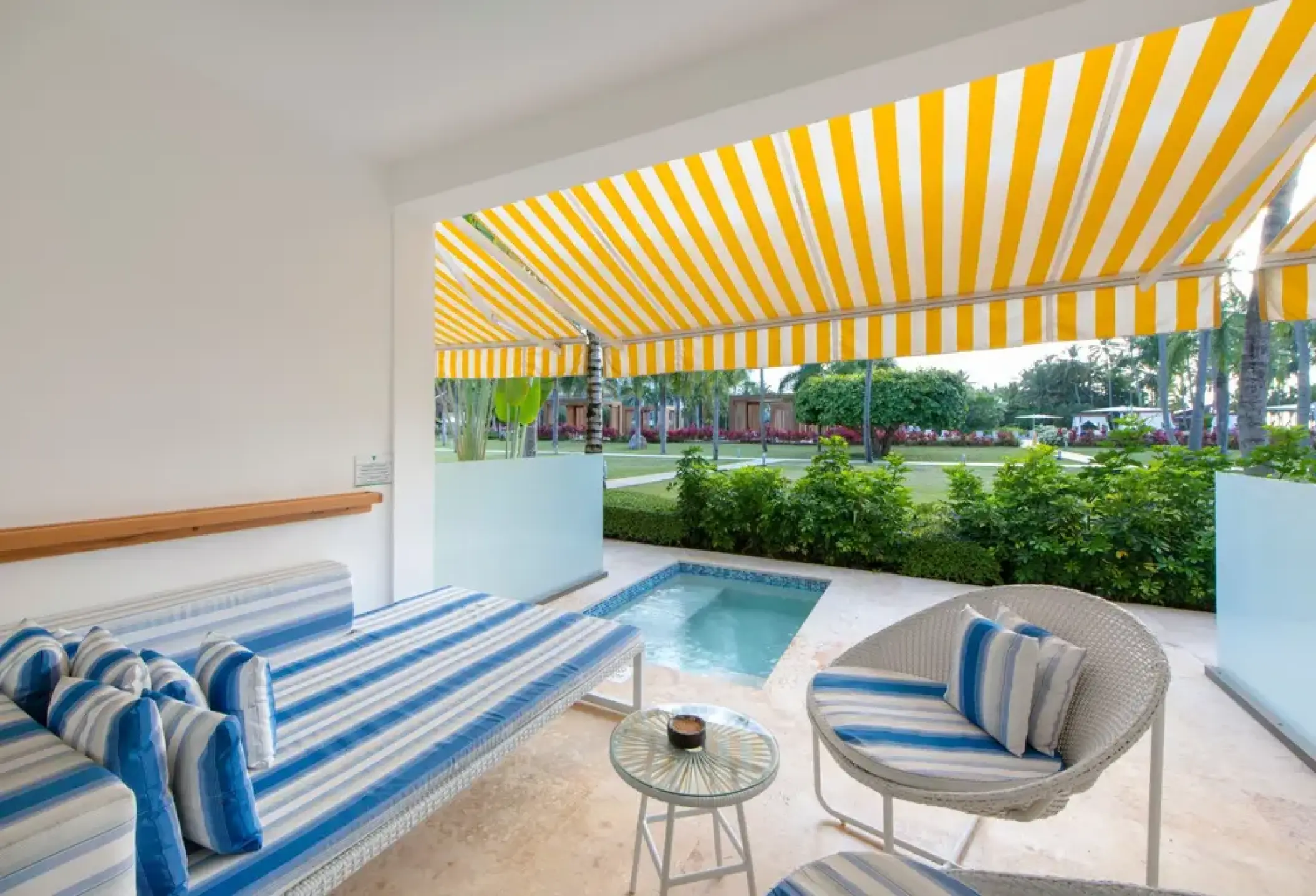Private pool suite terrace with a yellow awning and blue lounge seating at Viva V Samana, Samana