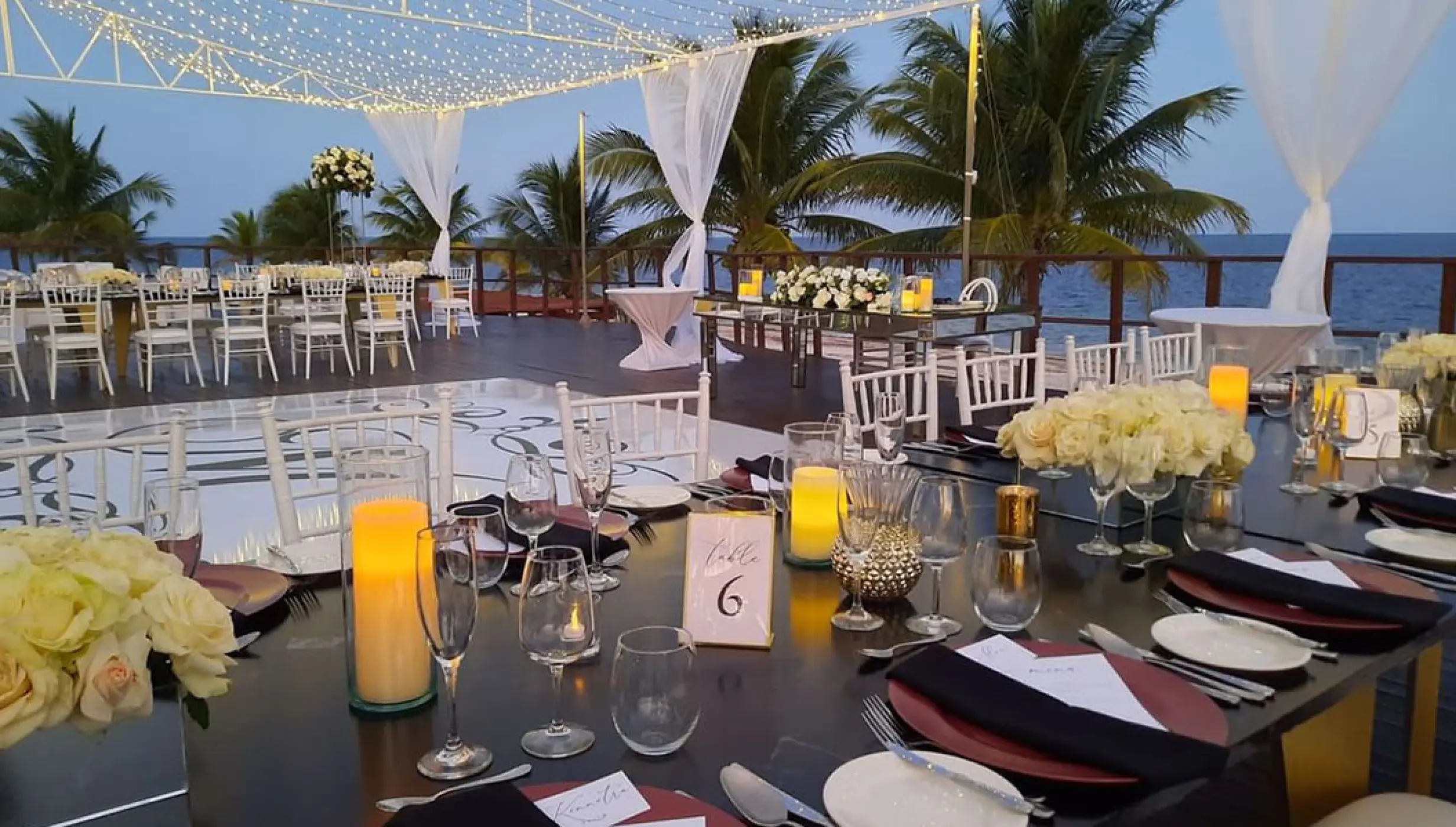 Reception setup at Vora Deck wedding venue at Haven Riviera Cancun Resort.
