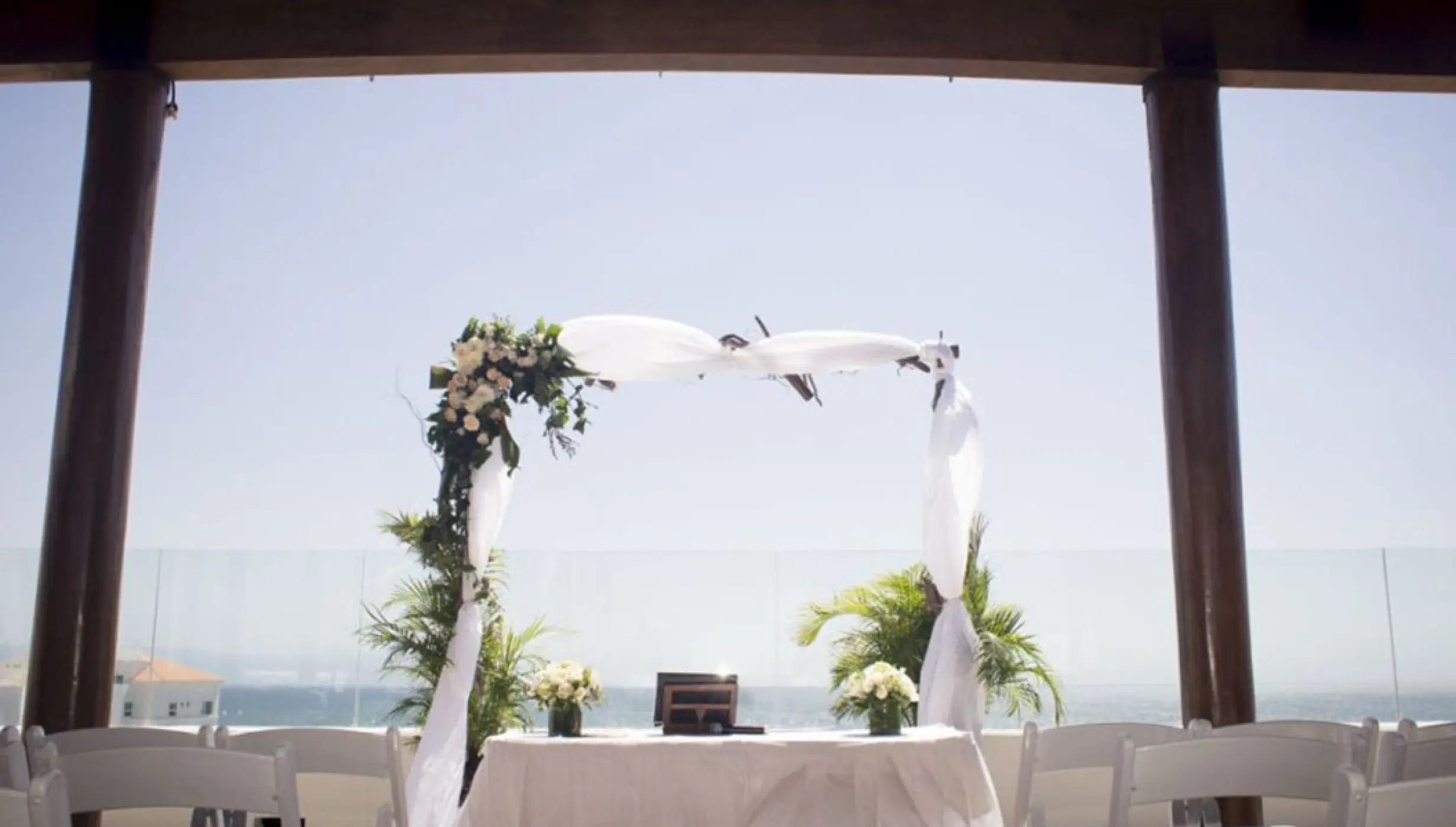 Rooftop wedding ceremony under a floral arch at Wyndham Alltra Riviera Nayarit, Puerto Vallarta