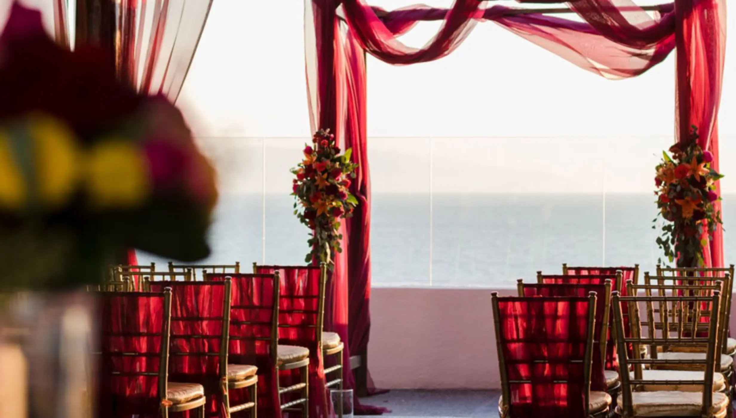 Rooftop wedding ceremony with red drapery at Wyndham Alltra Riviera Nayarit, Puerto Vallarta